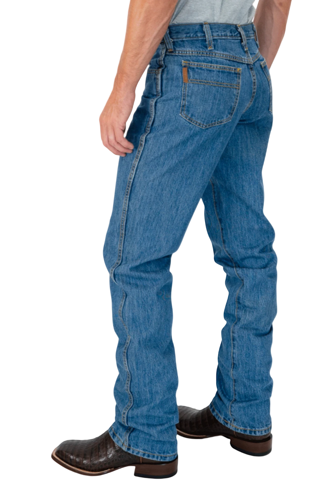 Person wearing blue jeans and brown boots on a white background