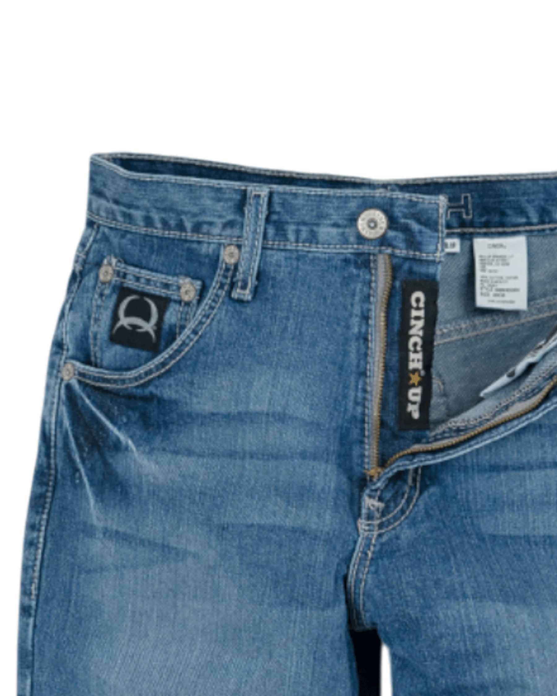 Close-up of blue jeans with a visible brand label on a white background
