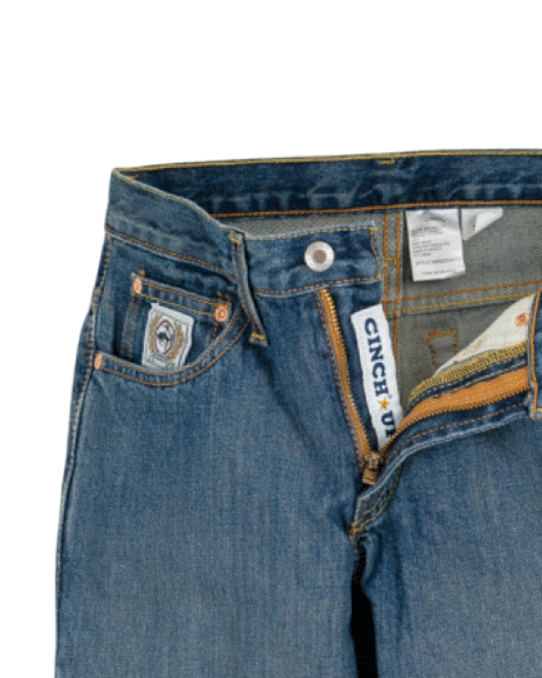Close-up of blue jeans with Cinch branding on a white background