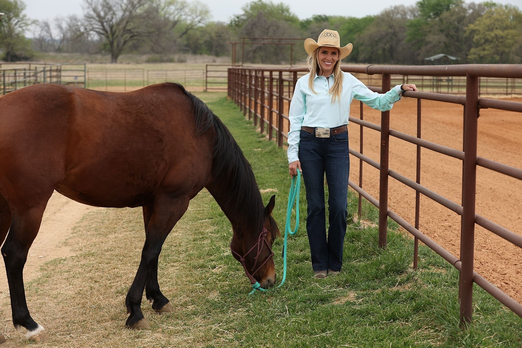 Go West Supply light turquoise long-sleeve button-down shirt with embroidered logo and pearl buttons, made of quick-drying poly-spandex blend.
