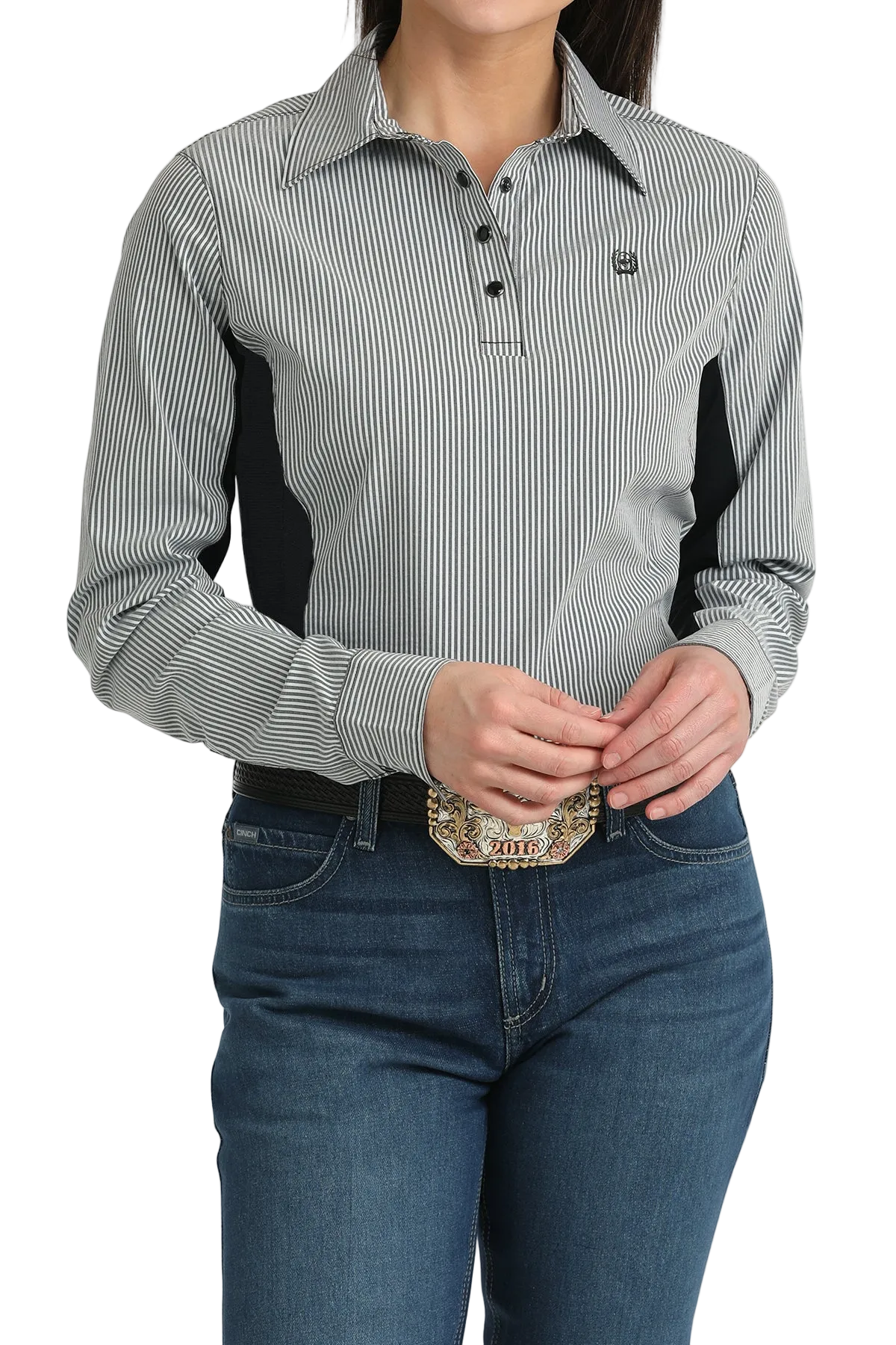 Person wearing a gray and black striped shirt with a logo, blue jeans, and a belt with a decorative buckle on a white background.