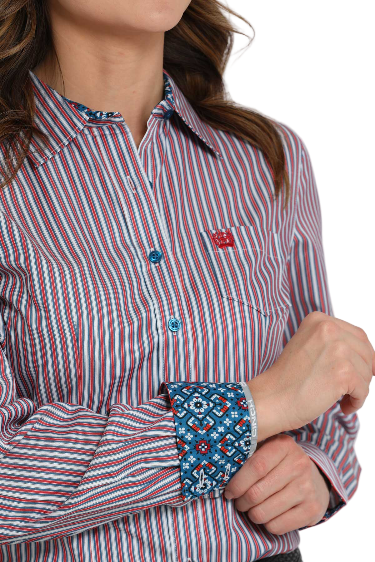 Close-up of a woman wearing a purple striped long-sleeve button-down shirt with contrasting cuffs