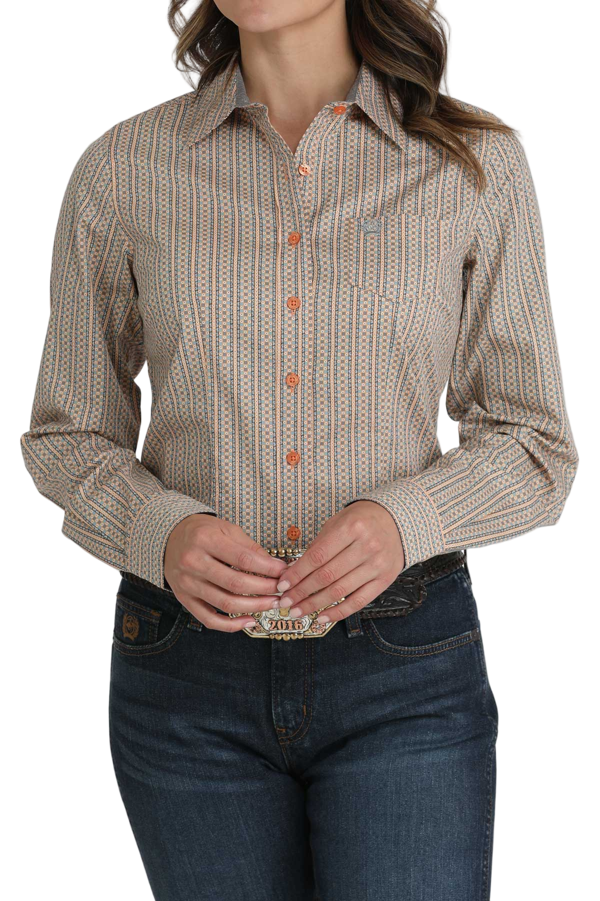 Woman wearing a brown striped button-down shirt, paired with dark blue jeans and a large silver western belt buckle