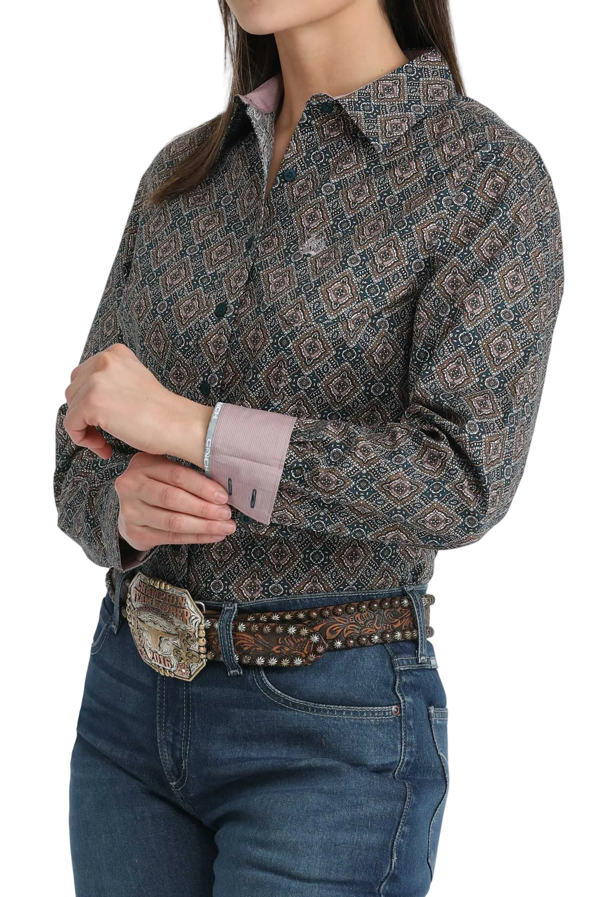 Person wearing a patterned shirt and jeans with a belt on a white background