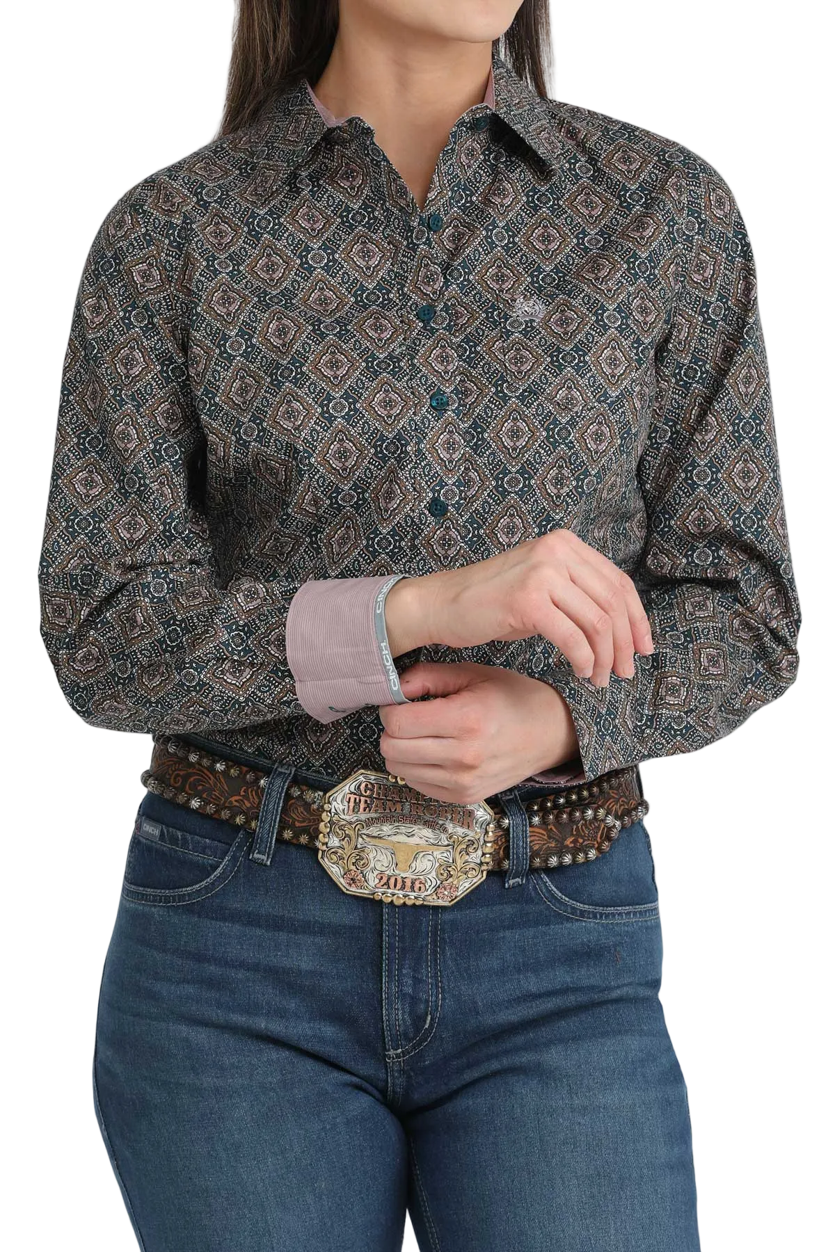 Person wearing a patterned shirt and jeans with a belt and buckle.