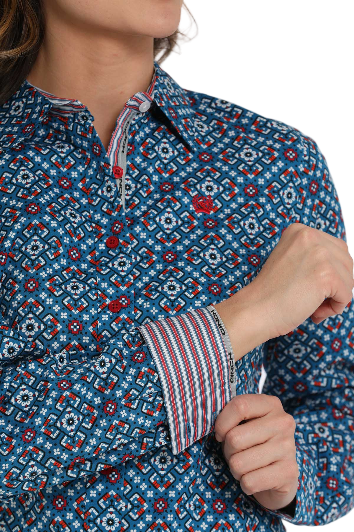 Woman wearing a blue patterned long-sleeve shirt with contrasting cuffs