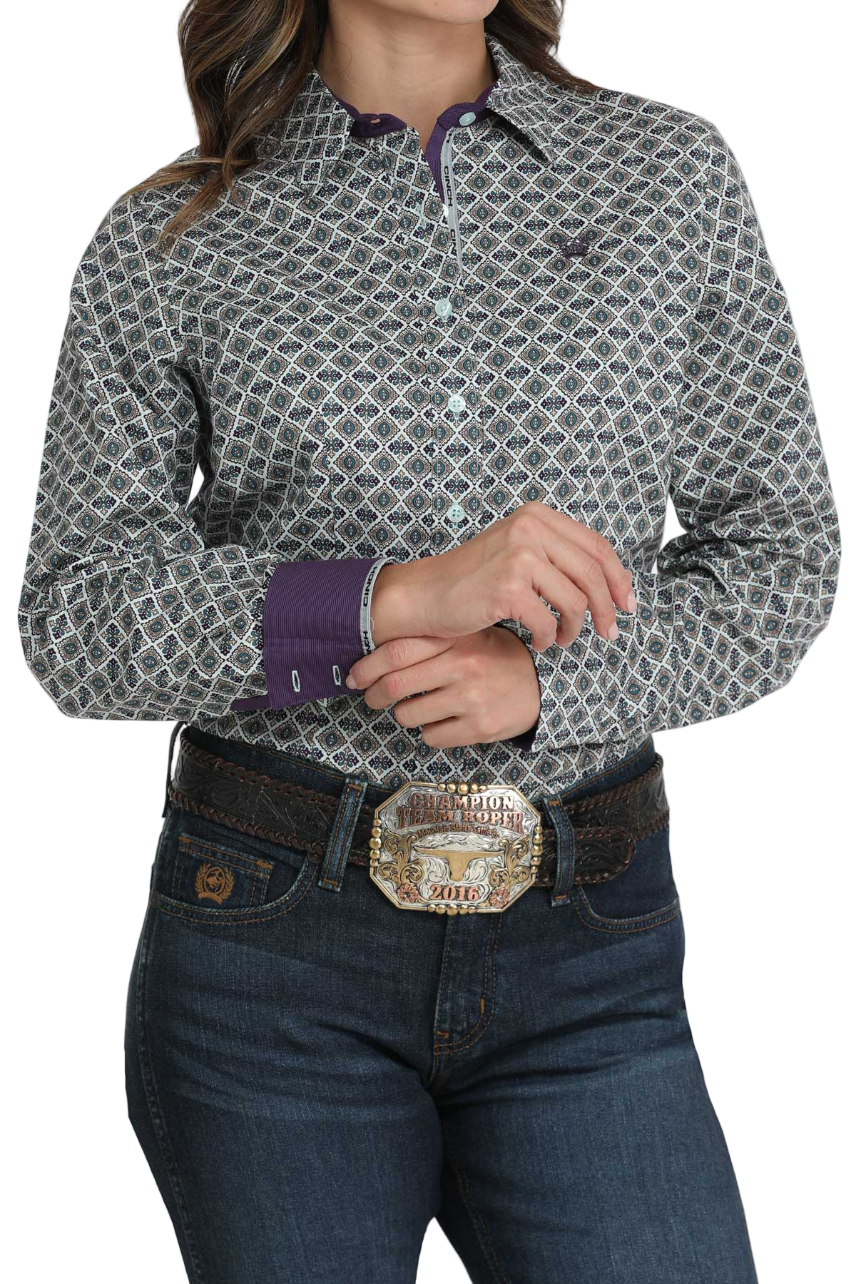 Woman wearing a patterned button-down shirt with purple contrast cuffs and collar trim, paired with jeans 