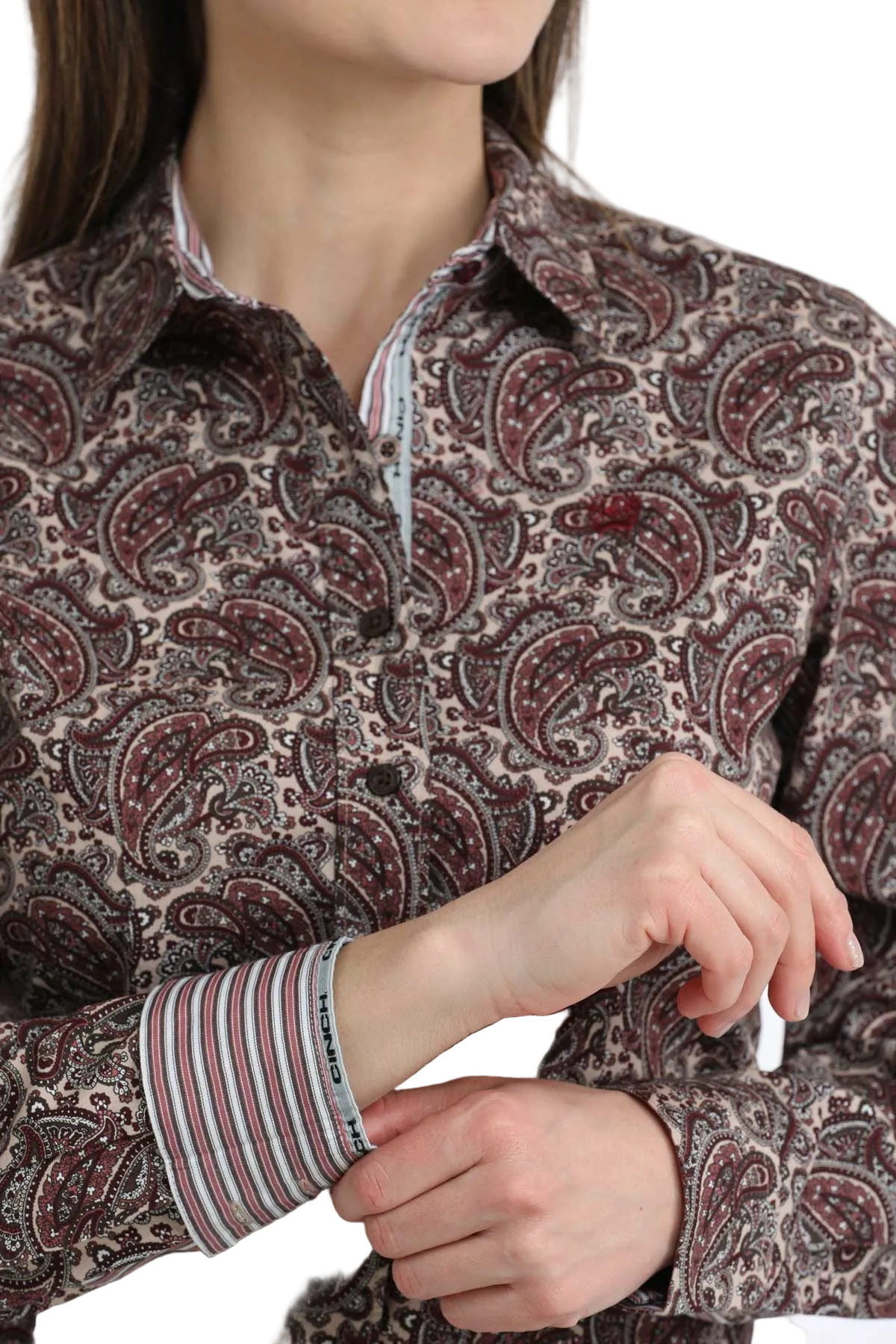 Close-up of a person wearing a patterned shirt with a focus on the collar and sleeves.