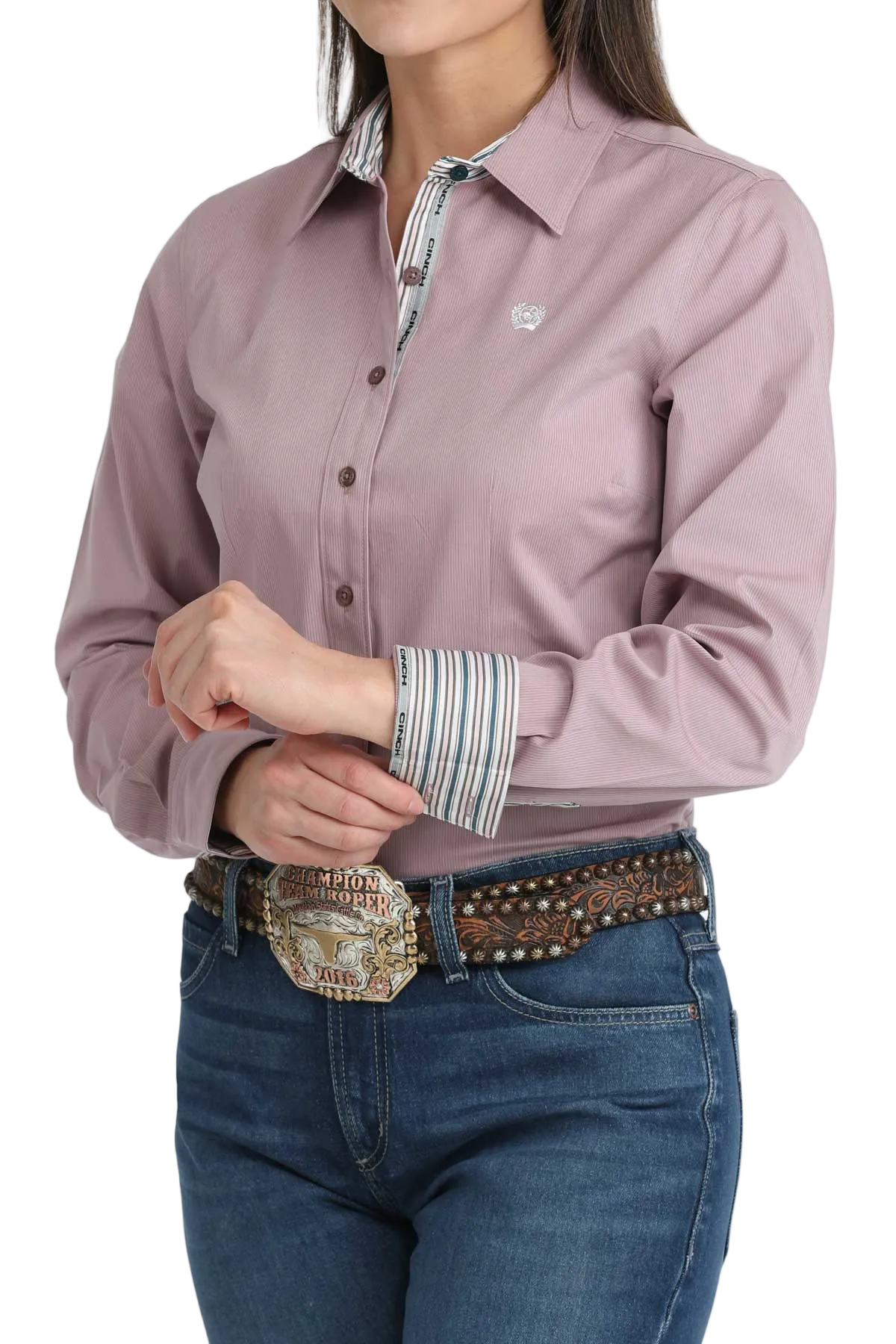 Person wearing a mauve shirt with a striped collar and blue jeans on a white background