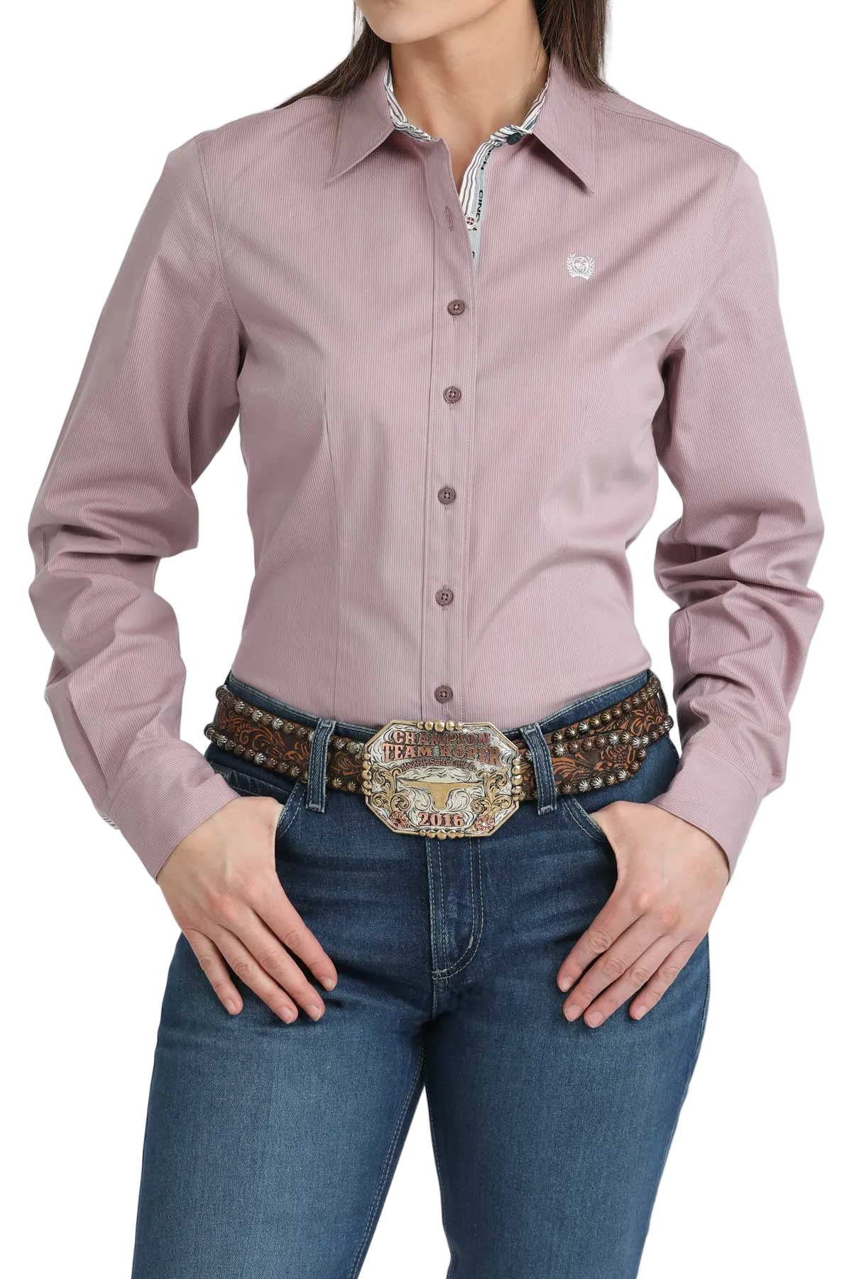 Person wearing a mauve button-up shirt and blue jeans with a decorative belt and buckle.