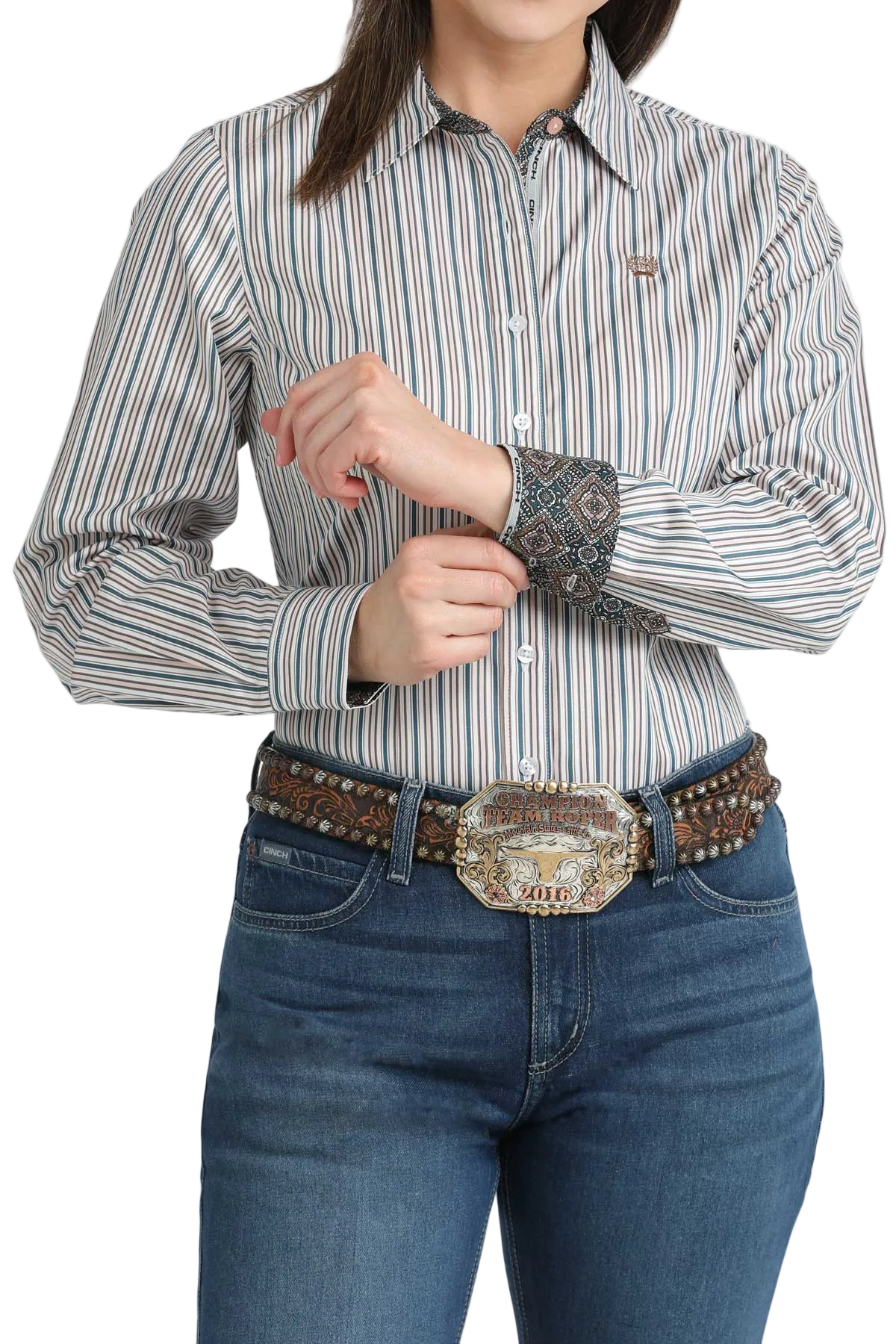 Person wearing a striped shirt and jeans with a belt and buckle.