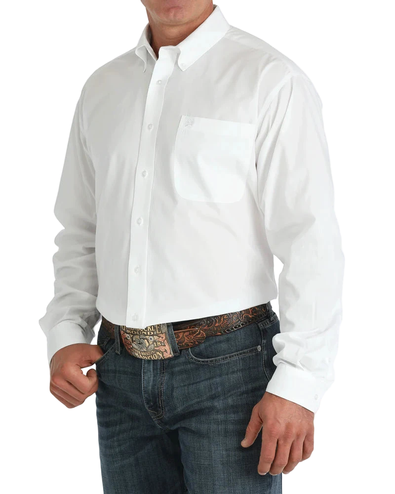 Man wearing a white button-up shirt with blue jeans on a white background