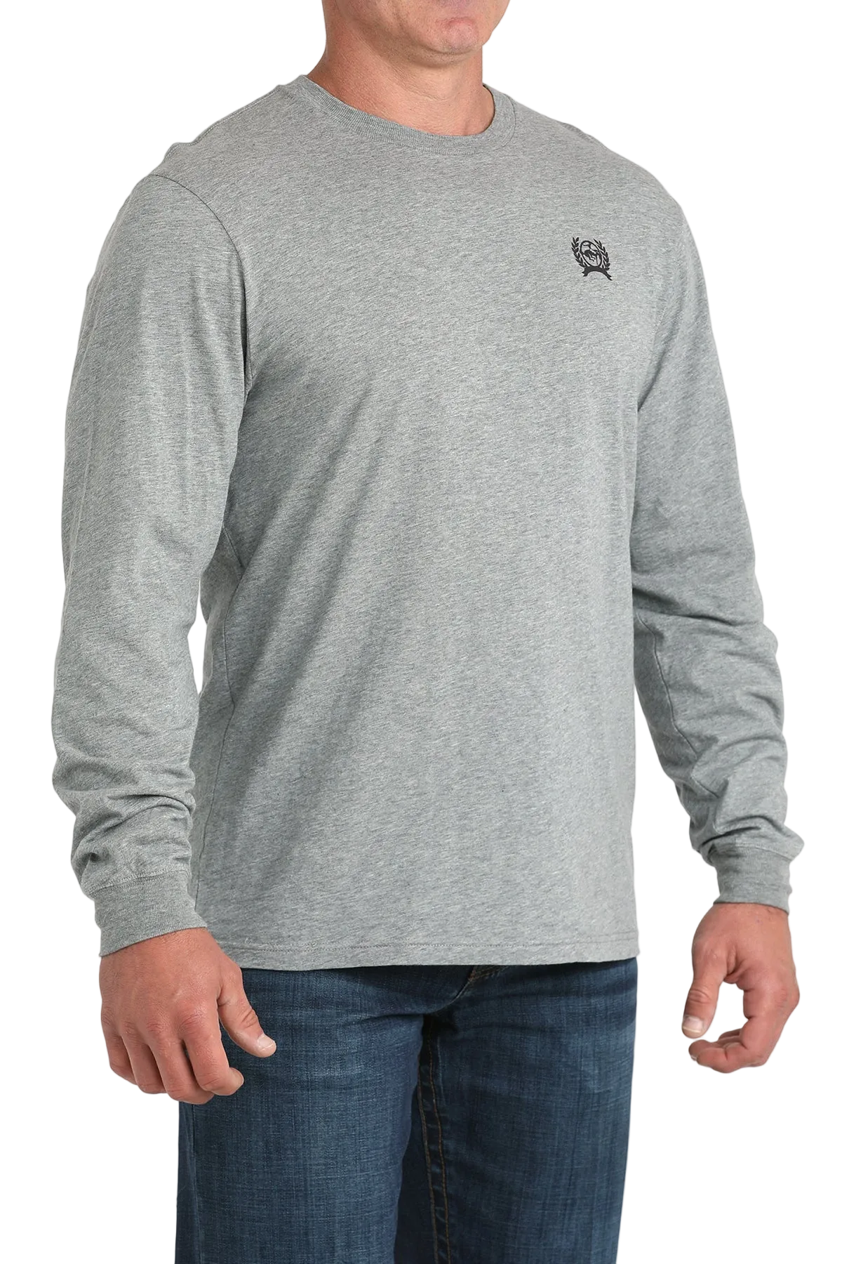 A man wearing a gray long-sleeve shirt and dark jeans stands against a transparent background.