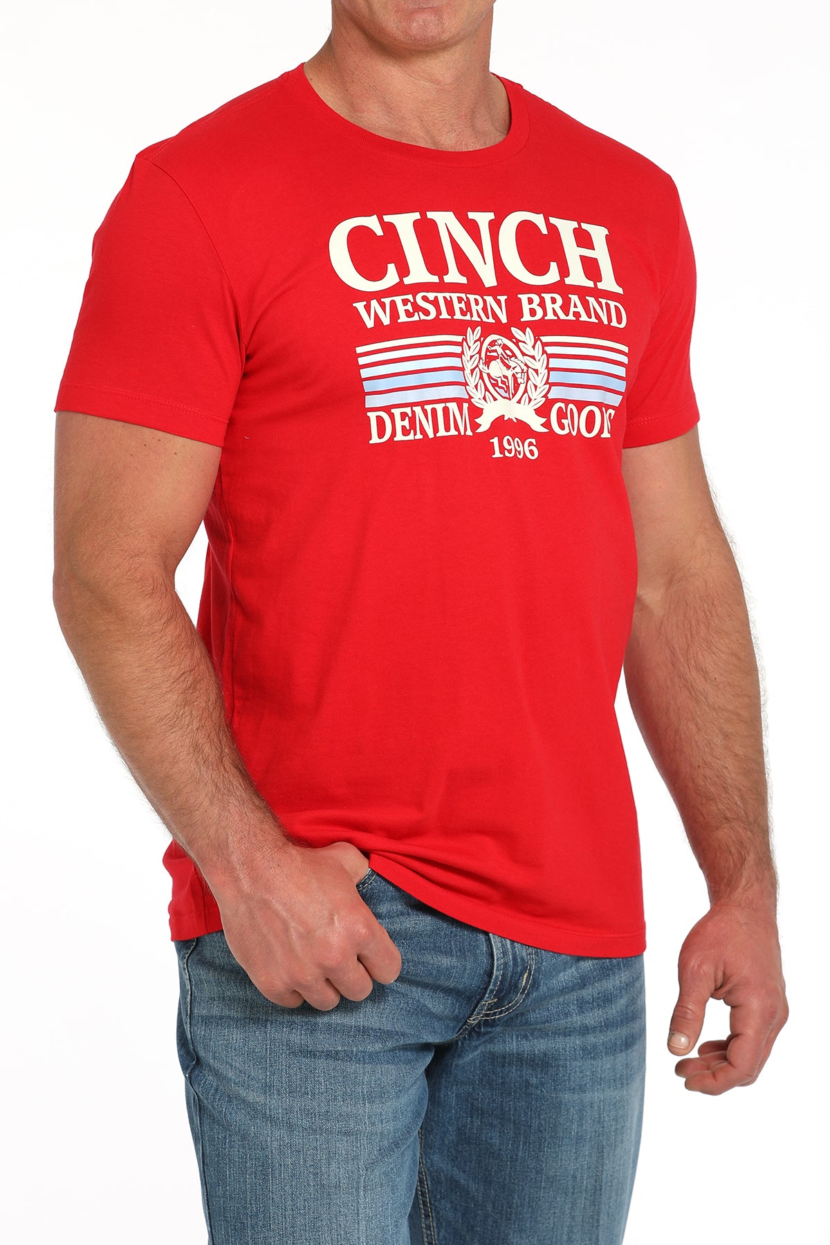 Man wearing a red t-shirt with a large 'Cinch' graphic on the front and blue jeans on a white background