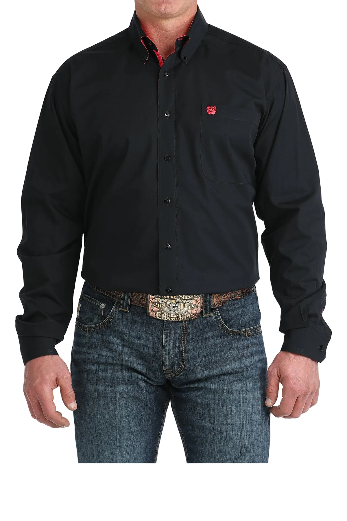 Man wearing a black shirt with a logo and jeans on a white background