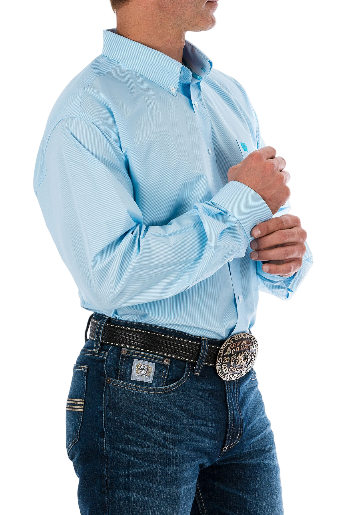 Man wearing a light blue button-up shirt and blue jeans on a white background