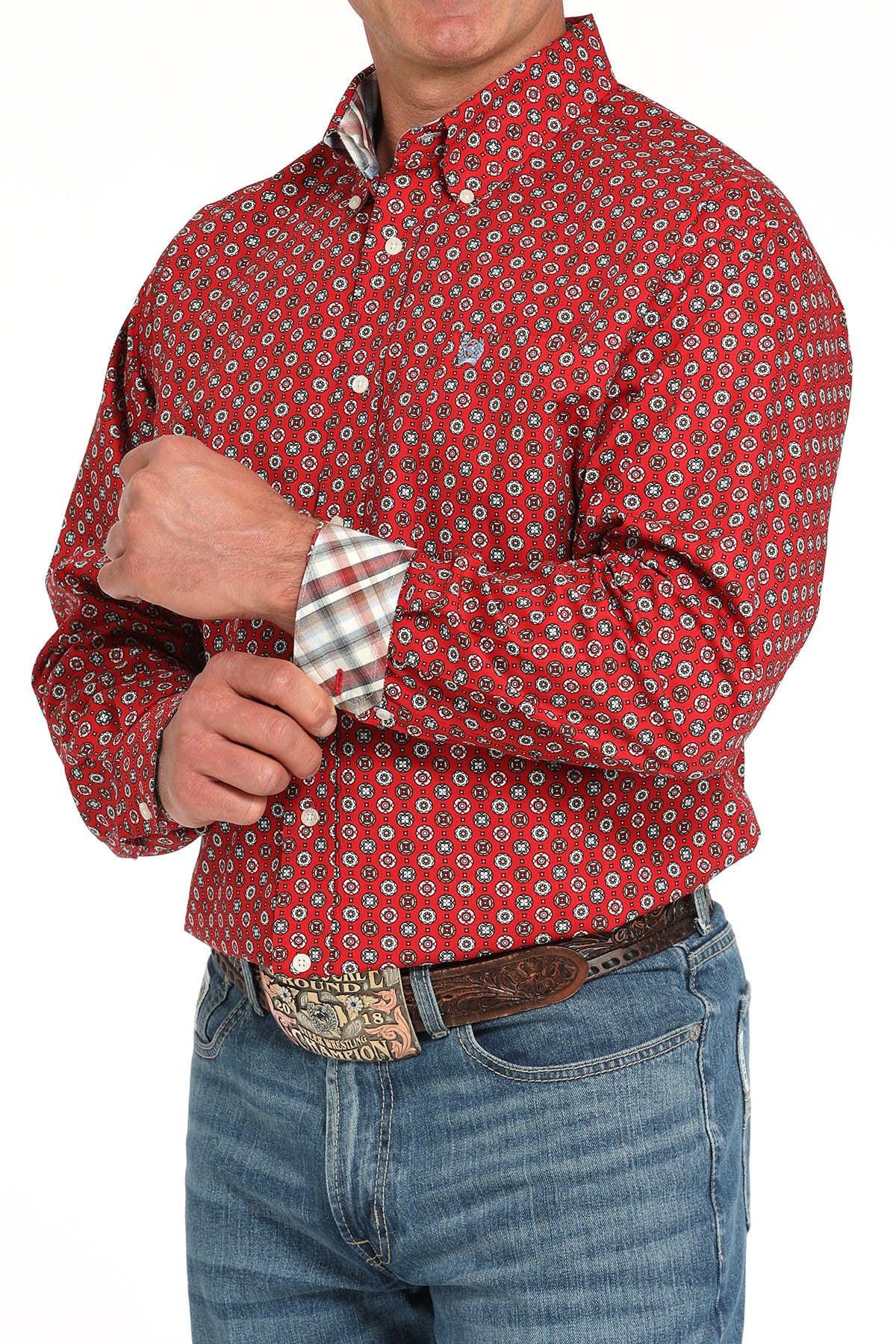 Man wearing a red long sleeve button-down with contrasting cuffs, paired with jeans and a belt 