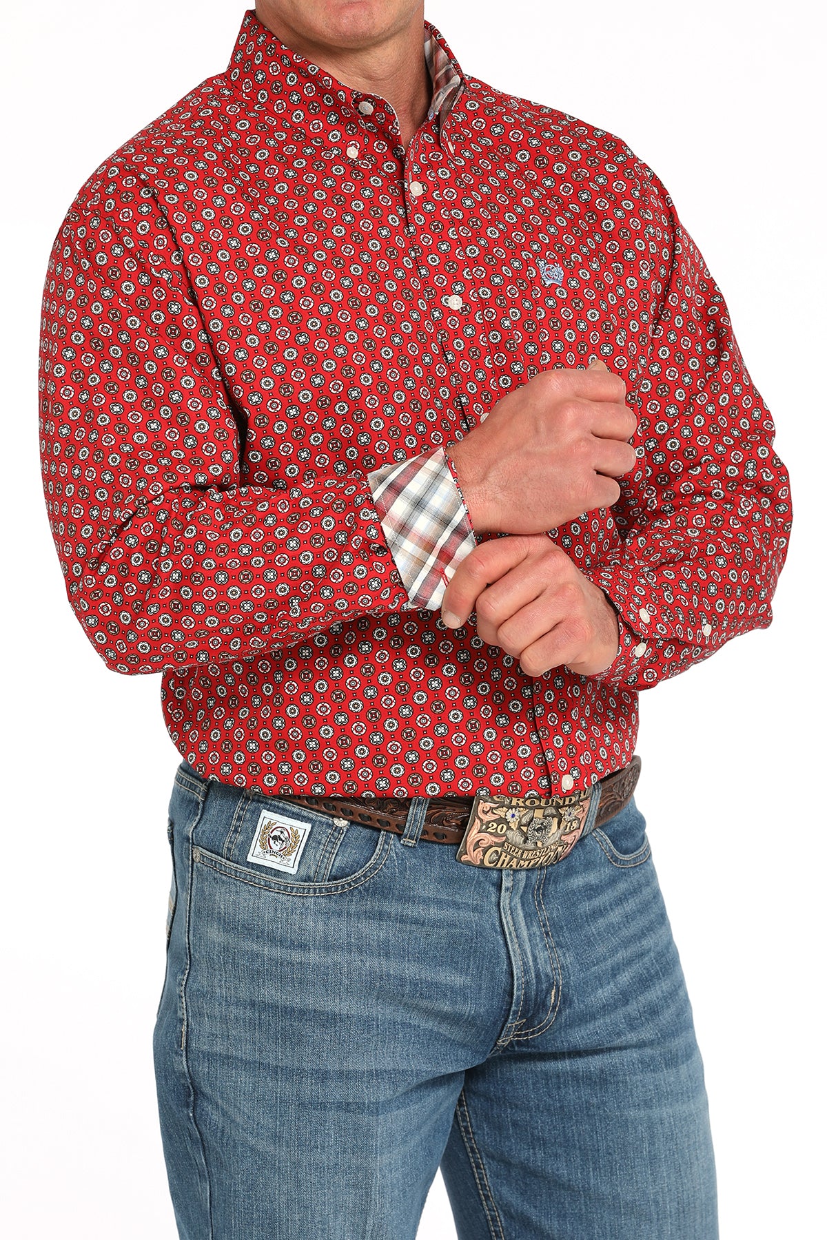 Man wearing a red long sleeve button-down with contrasting cuffs, paired with jeans and a belt 
