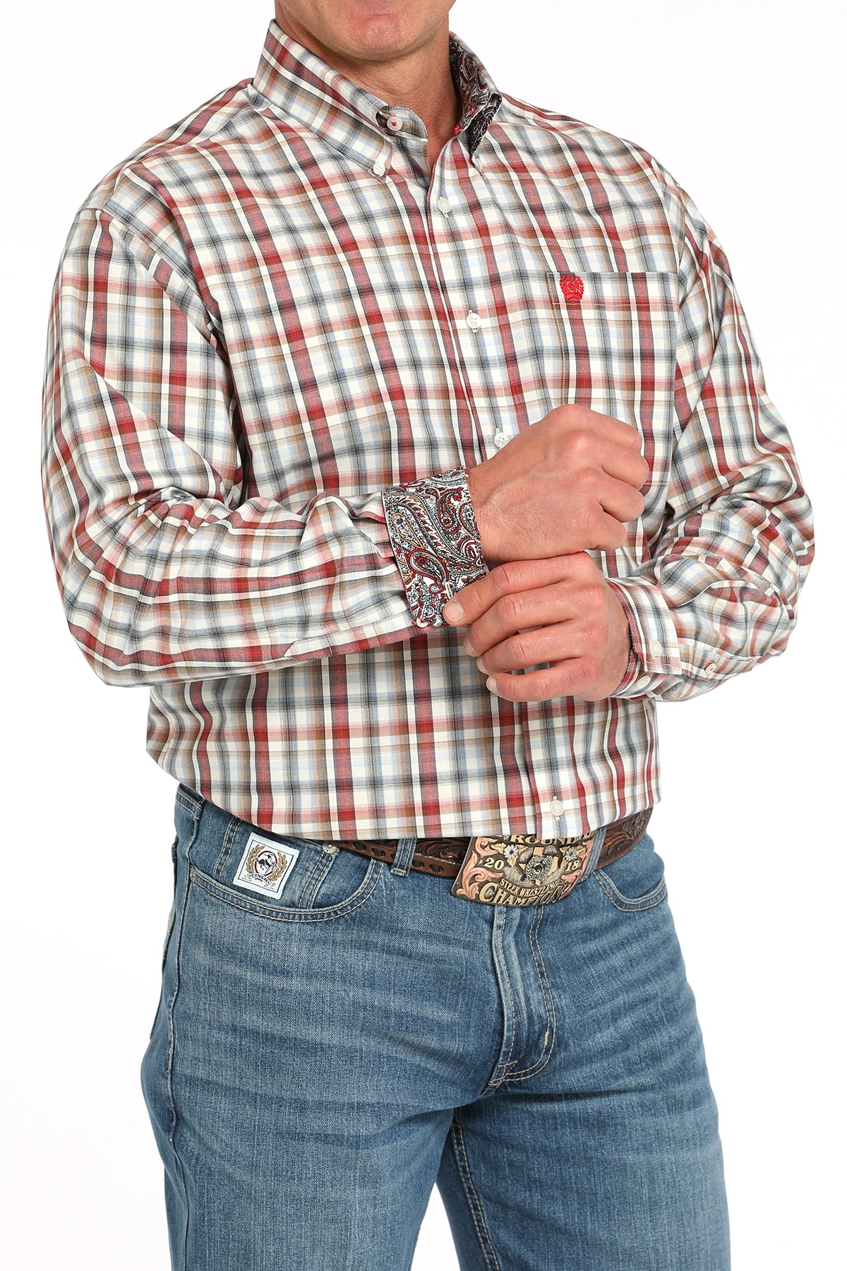 Man wearing a plaid long sleeve button-down shirt with contrasting cuffs, paired with jeans and a belt 