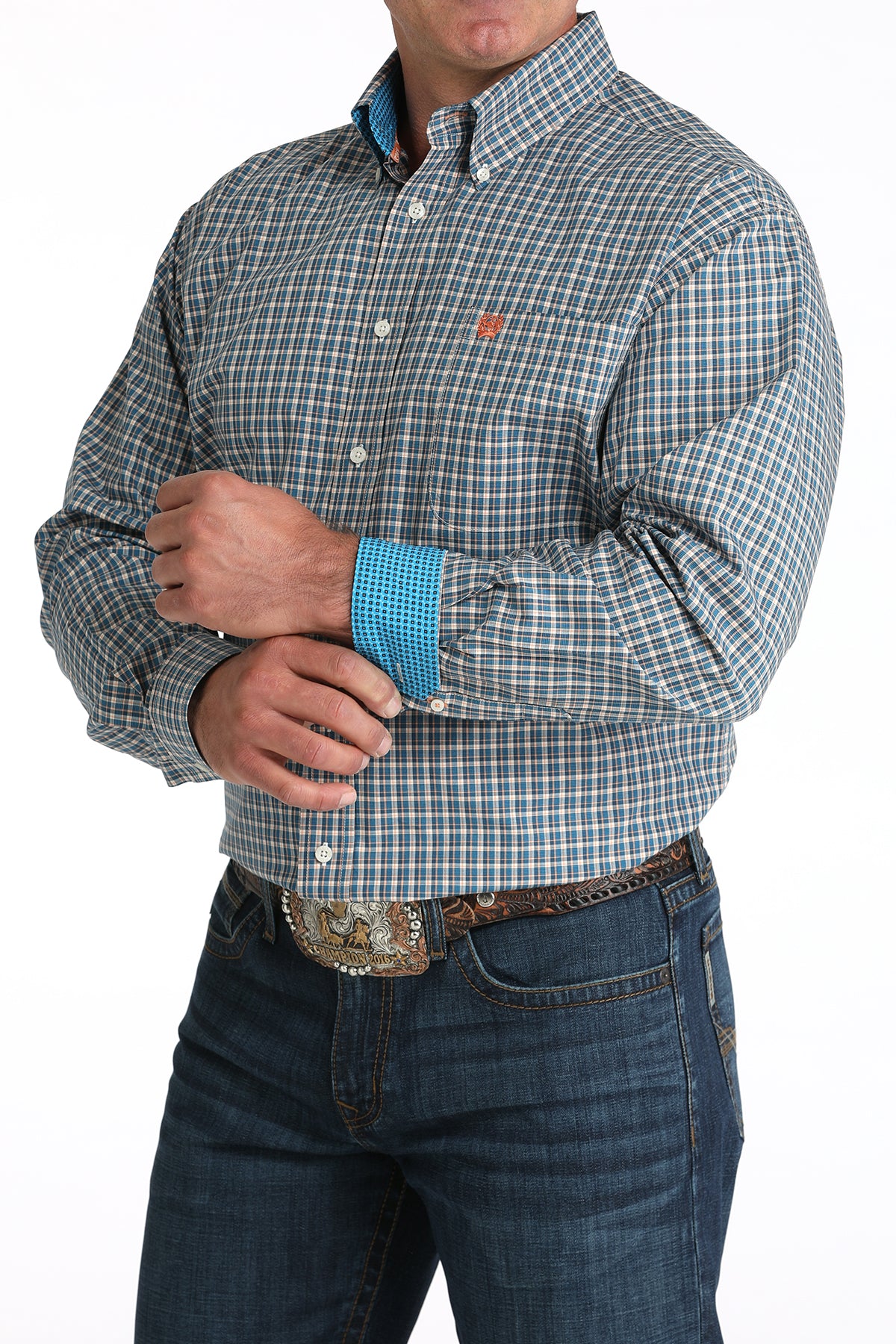Man wearing a plaid shirt with rolled-up sleeves and jeans on a white background