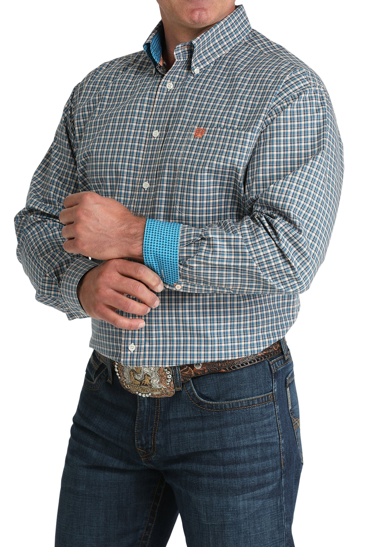 Man wearing a patterned blue long sleeve button-down shirt with contrasting cuffs and jeans on a transparent background 