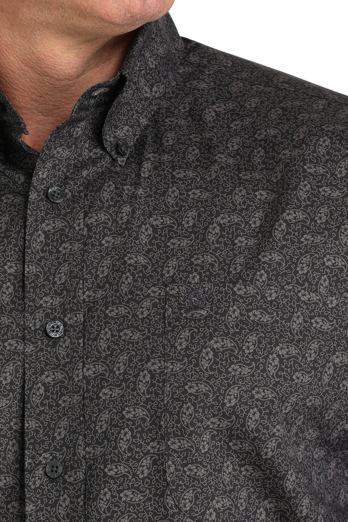 Close-up of a man wearing a patterned black long sleeve button-down shirt on a transparent background 