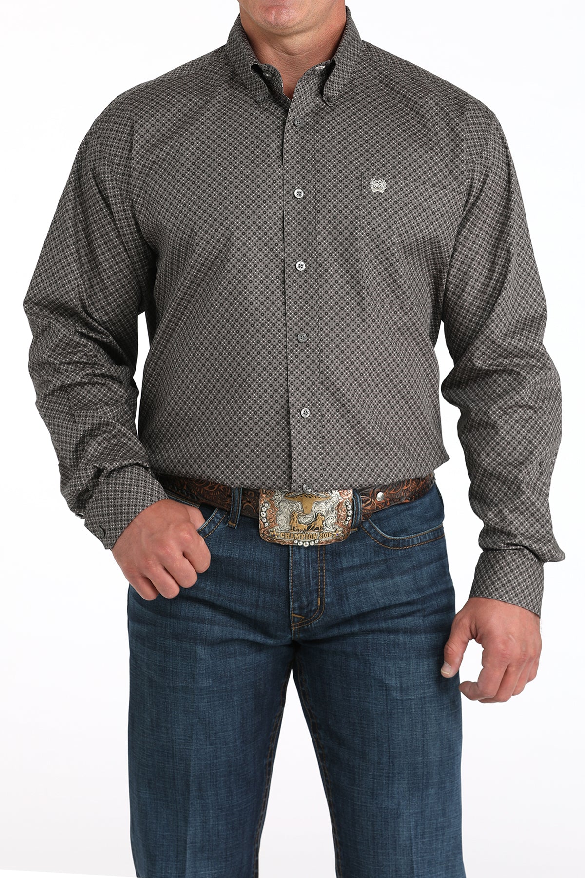 Man wearing a patterned button-up shirt and jeans on a white background