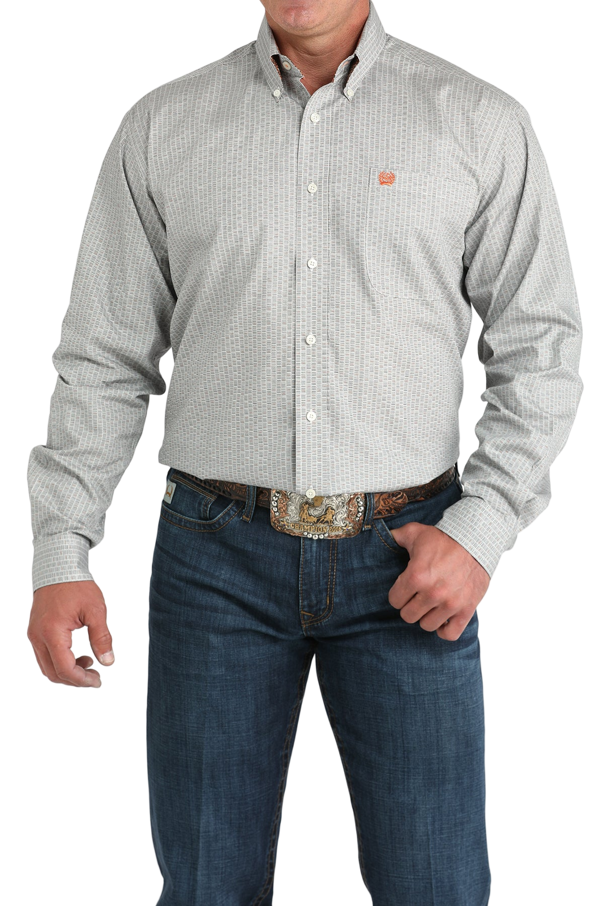 Man wearing a light gray patterned button-up shirt with blue jeans on a white background