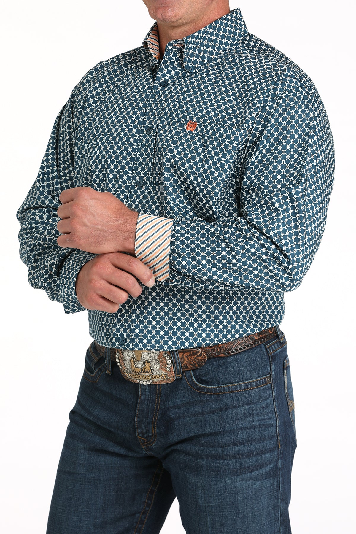 Man wearing a teal long sleeve button-down shirt with contrasting cuffs, paired with jeans and a belt 