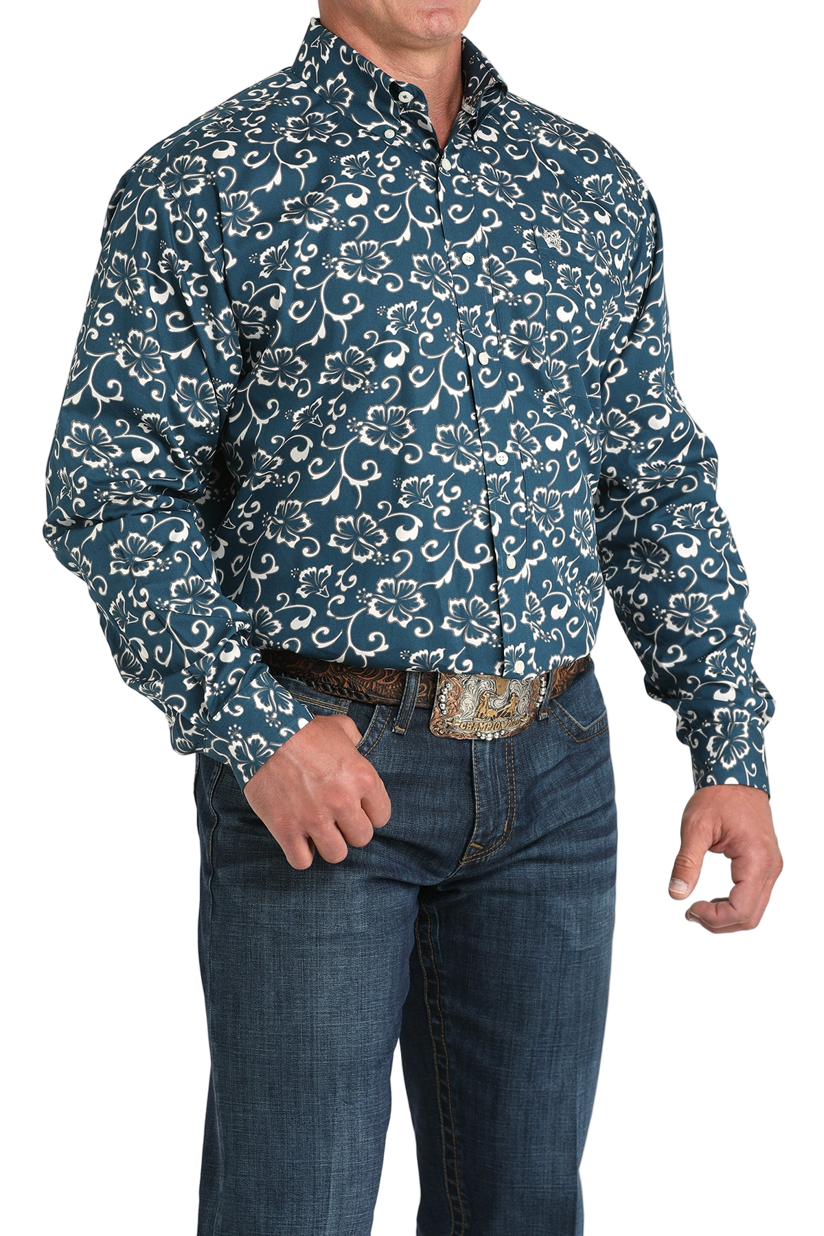 Man wearing a blue patterned button-up shirt with blue jeans on a white background