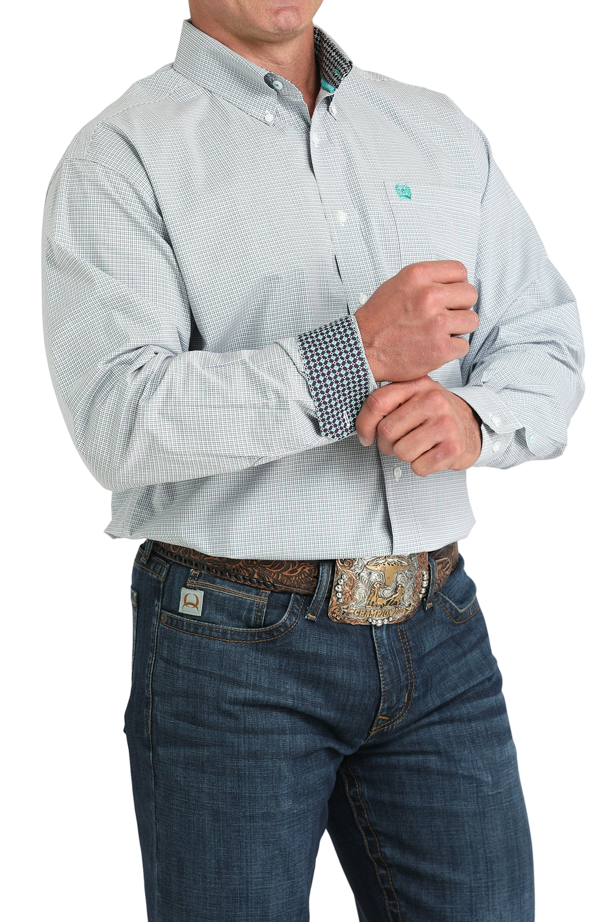 Man wearing a patterned light blue long sleeve button-down shirt with contrasting cuffs and jeans on a transparent background 
