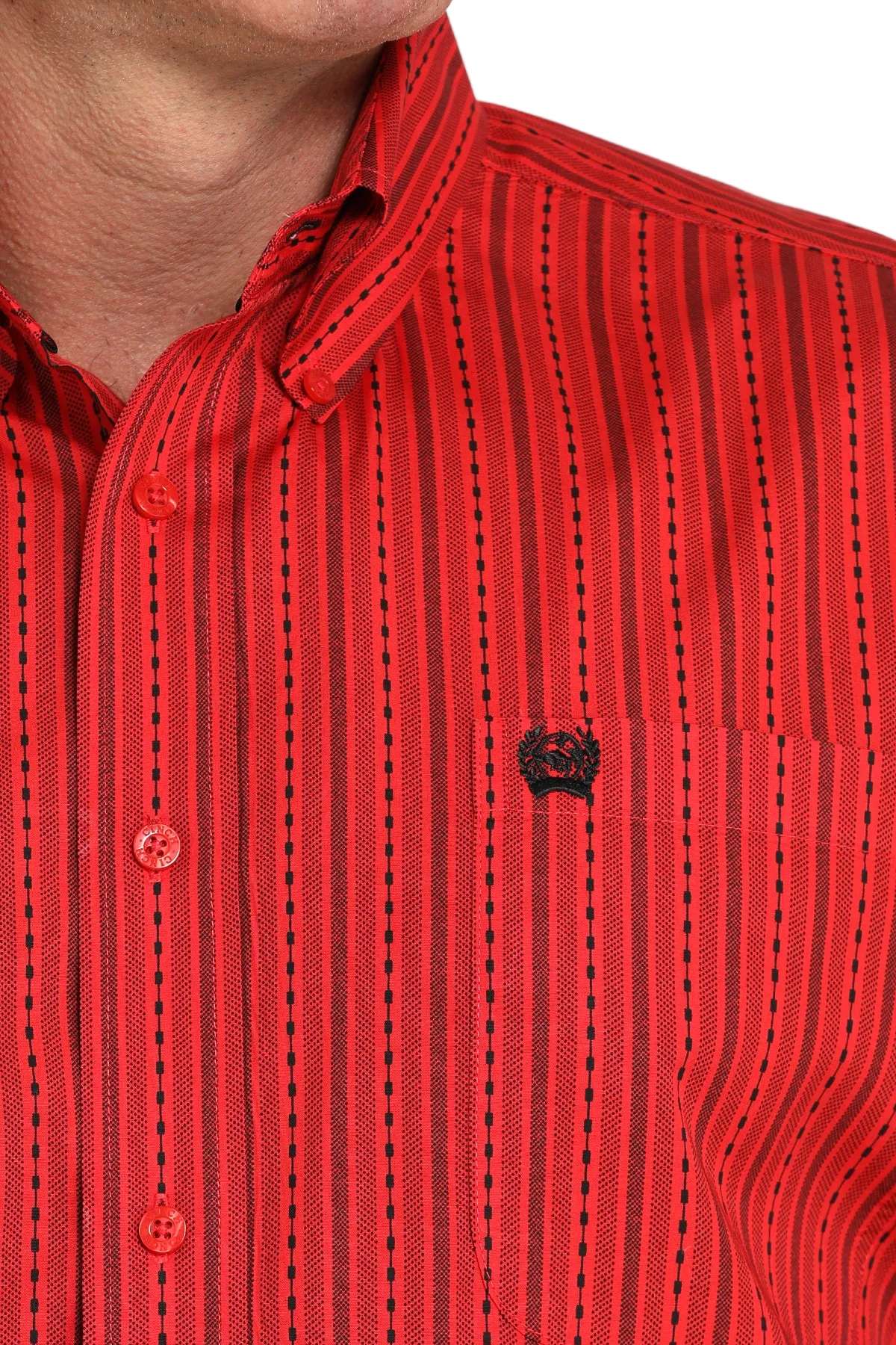 Close-up of a man wearing a red striped button-up shirt with a small black emblem on the chest, displayed against a transparent background
