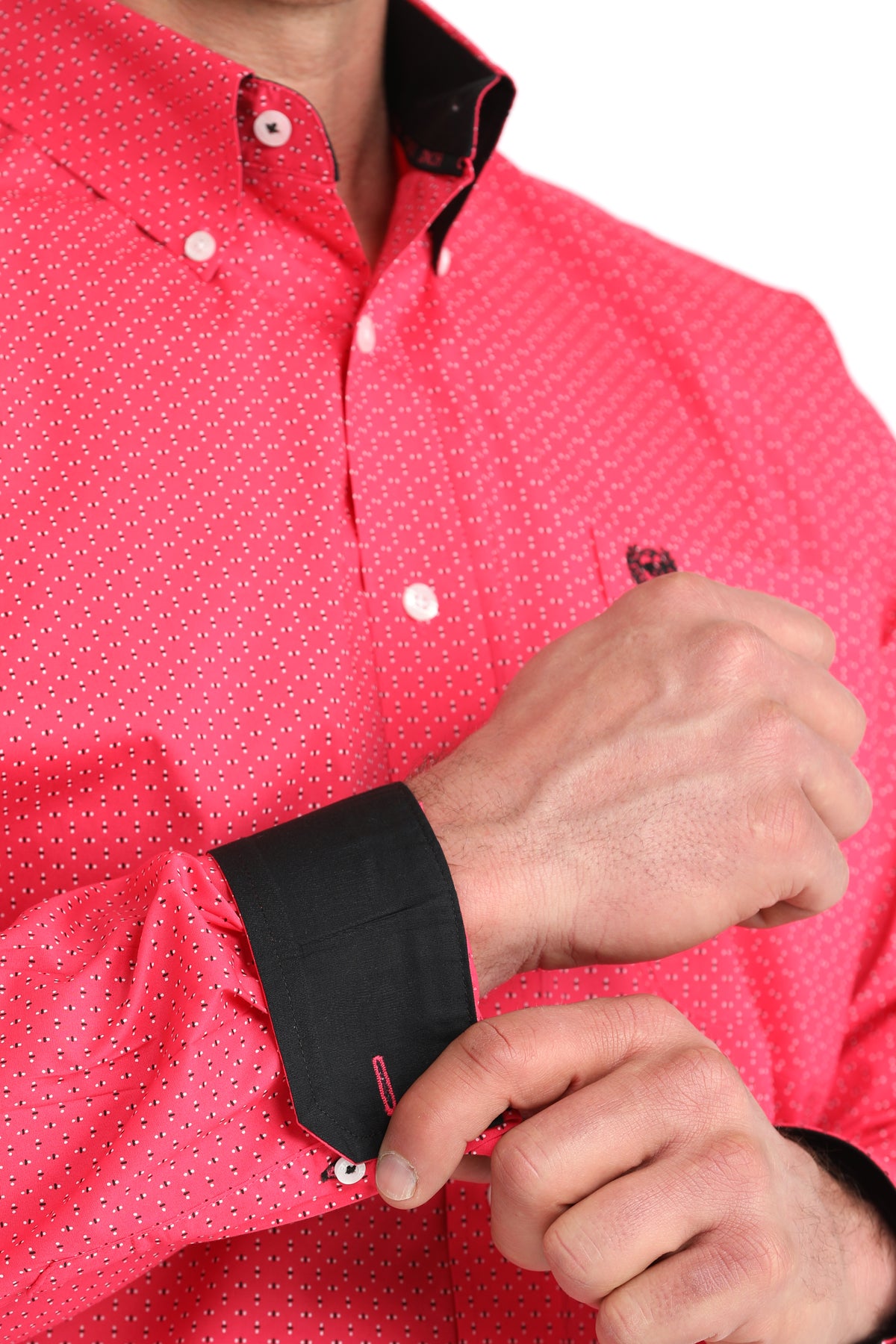 Close-up of a person wearing a red patterned shirt with black cuffs and collar.