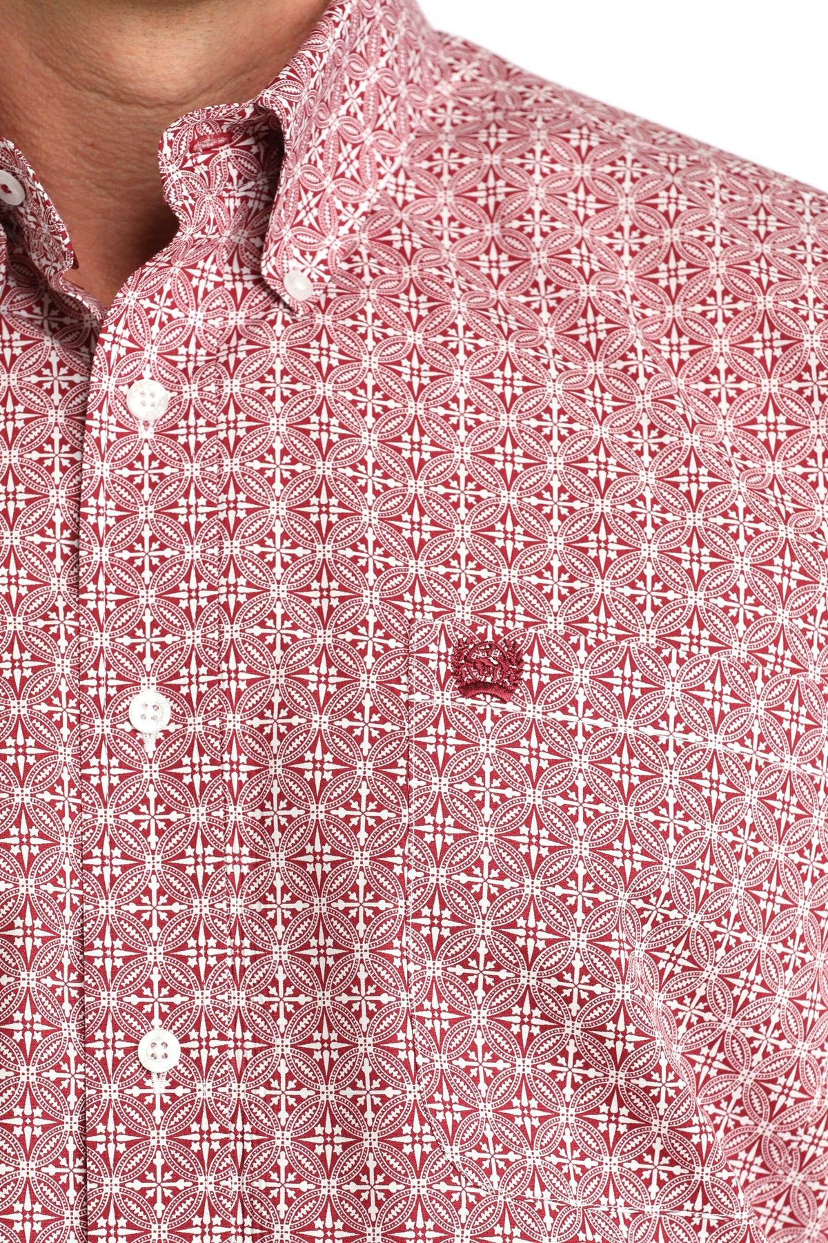 Close-up of a red patterned shirt with white geometric design