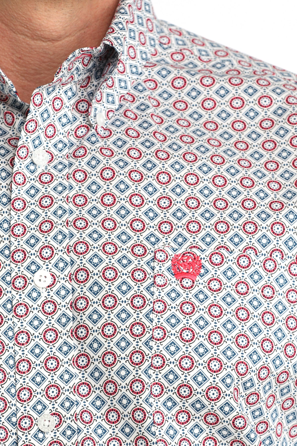 Close-up of a patterned shirt with red and blue geometric design