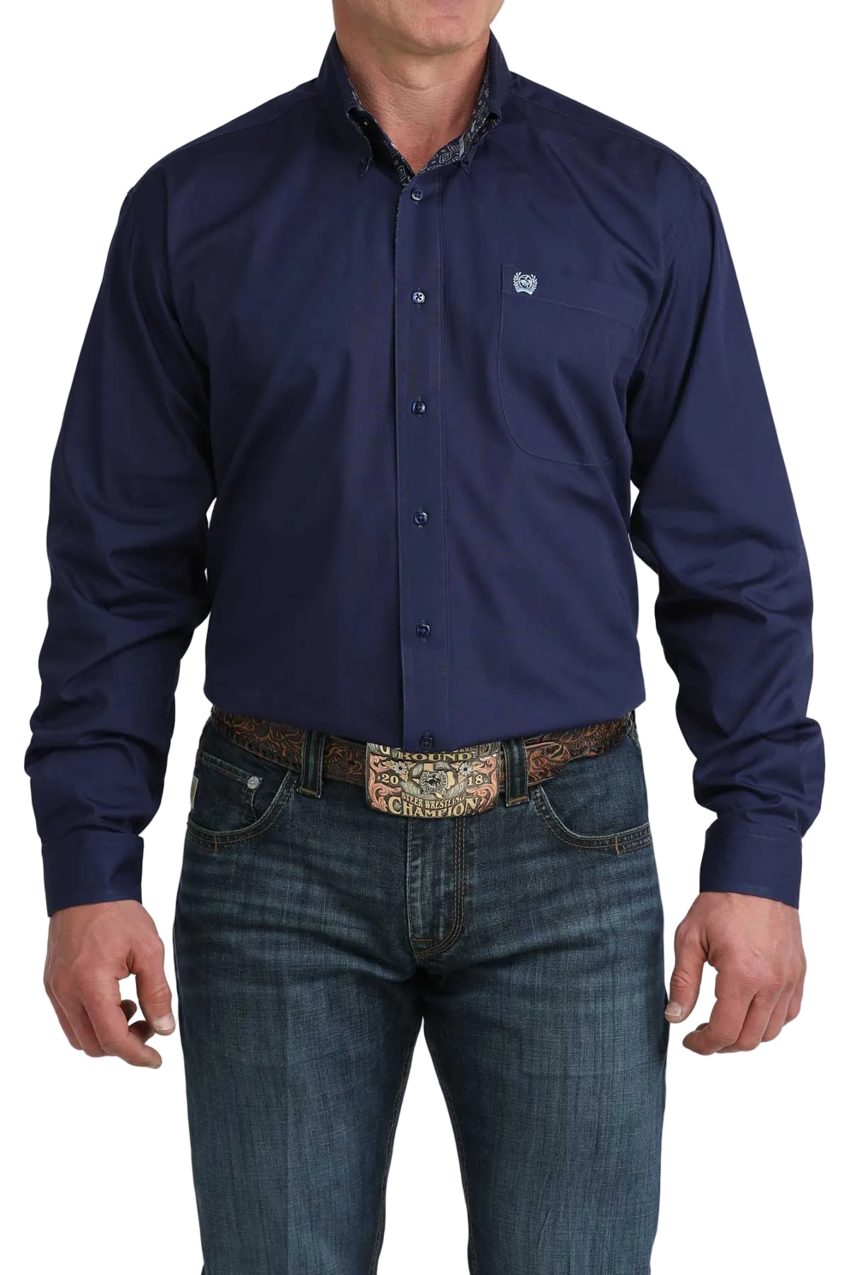 Man wearing a navy blue button-up shirt and jeans on a white background