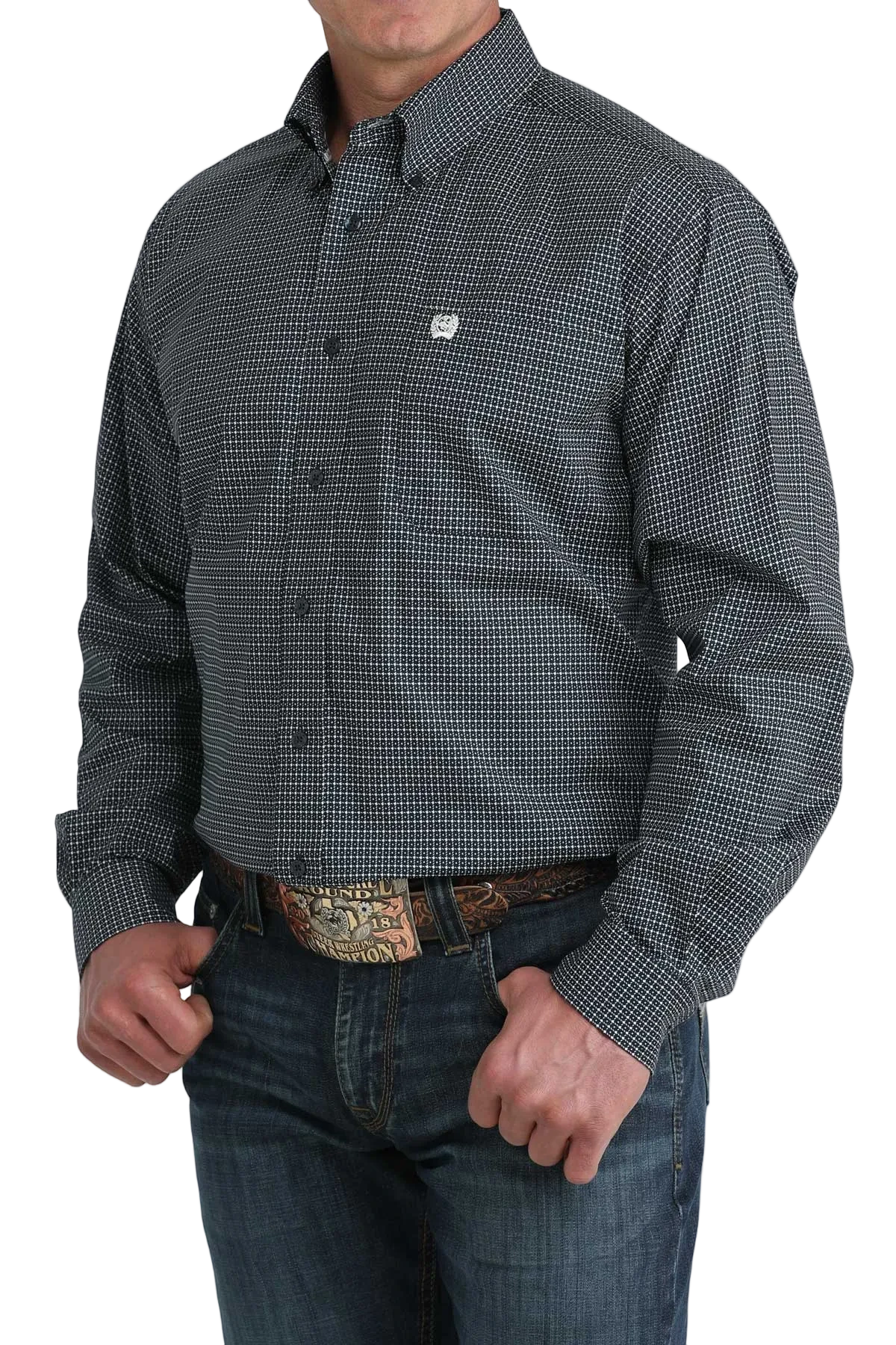 Man wearing a patterned shirt and jeans on a white background