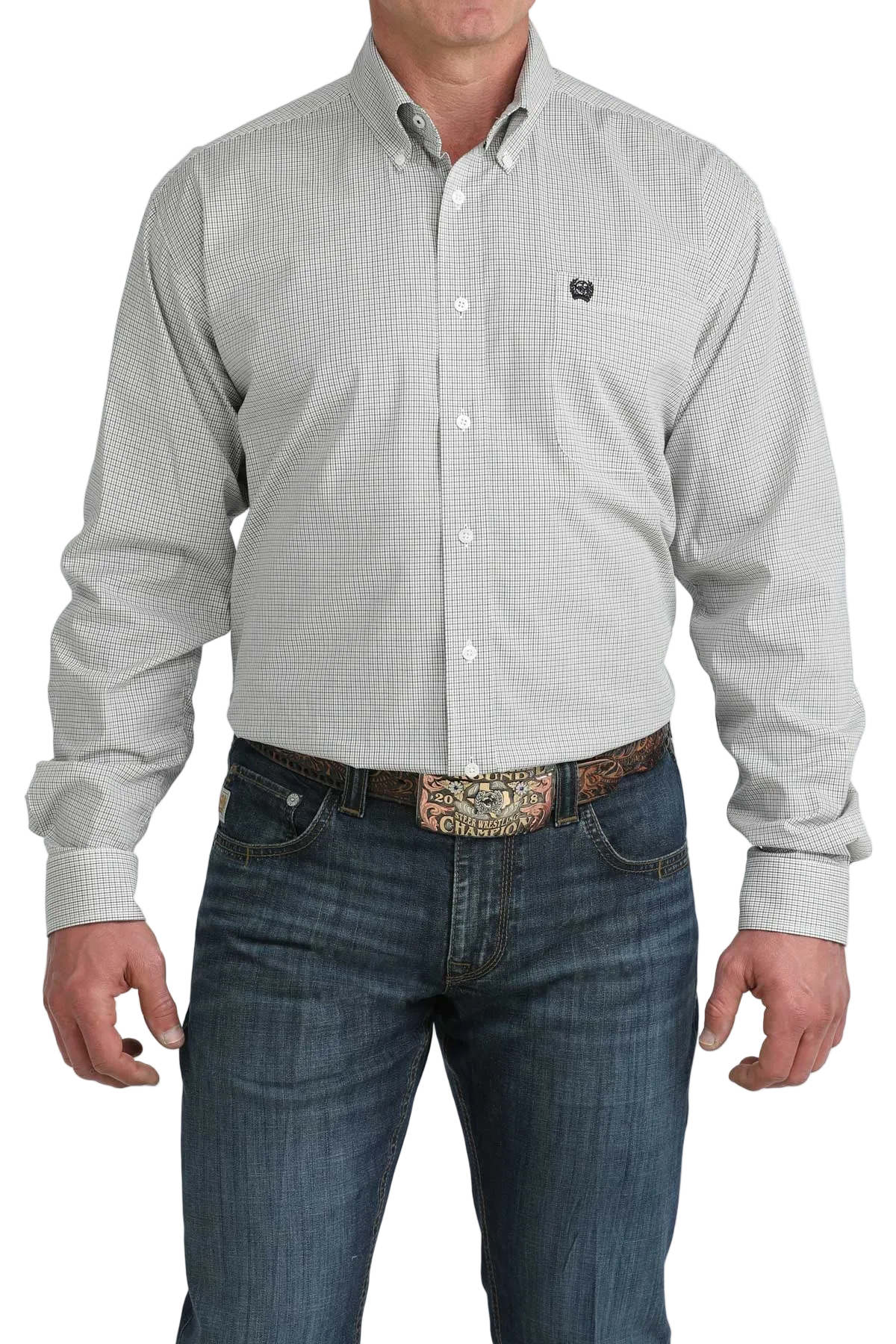 Man wearing a light gray patterned shirt and blue jeans with a decorative belt on a white background
