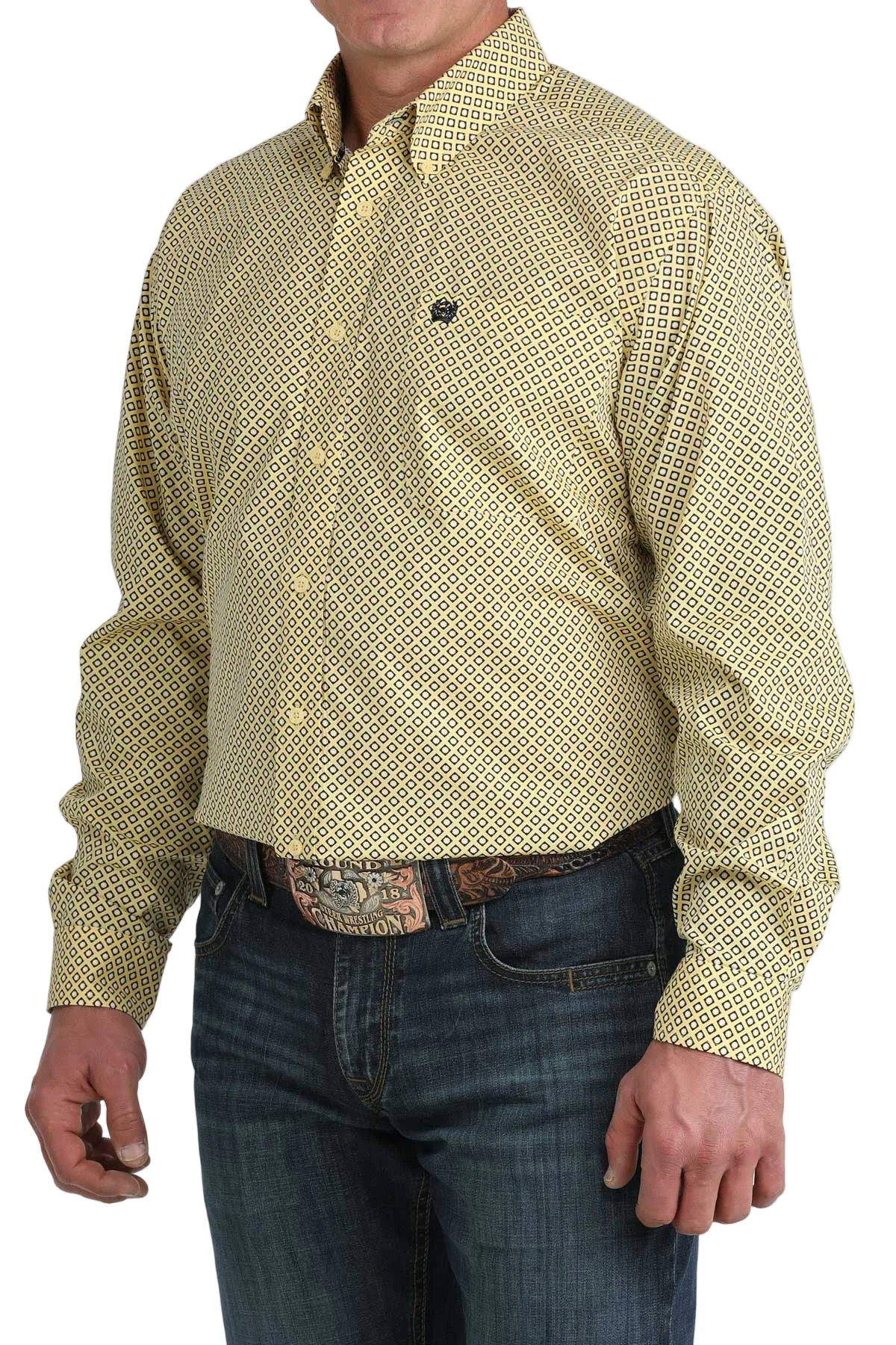 Man wearing a patterned yellow shirt and jeans on a white background