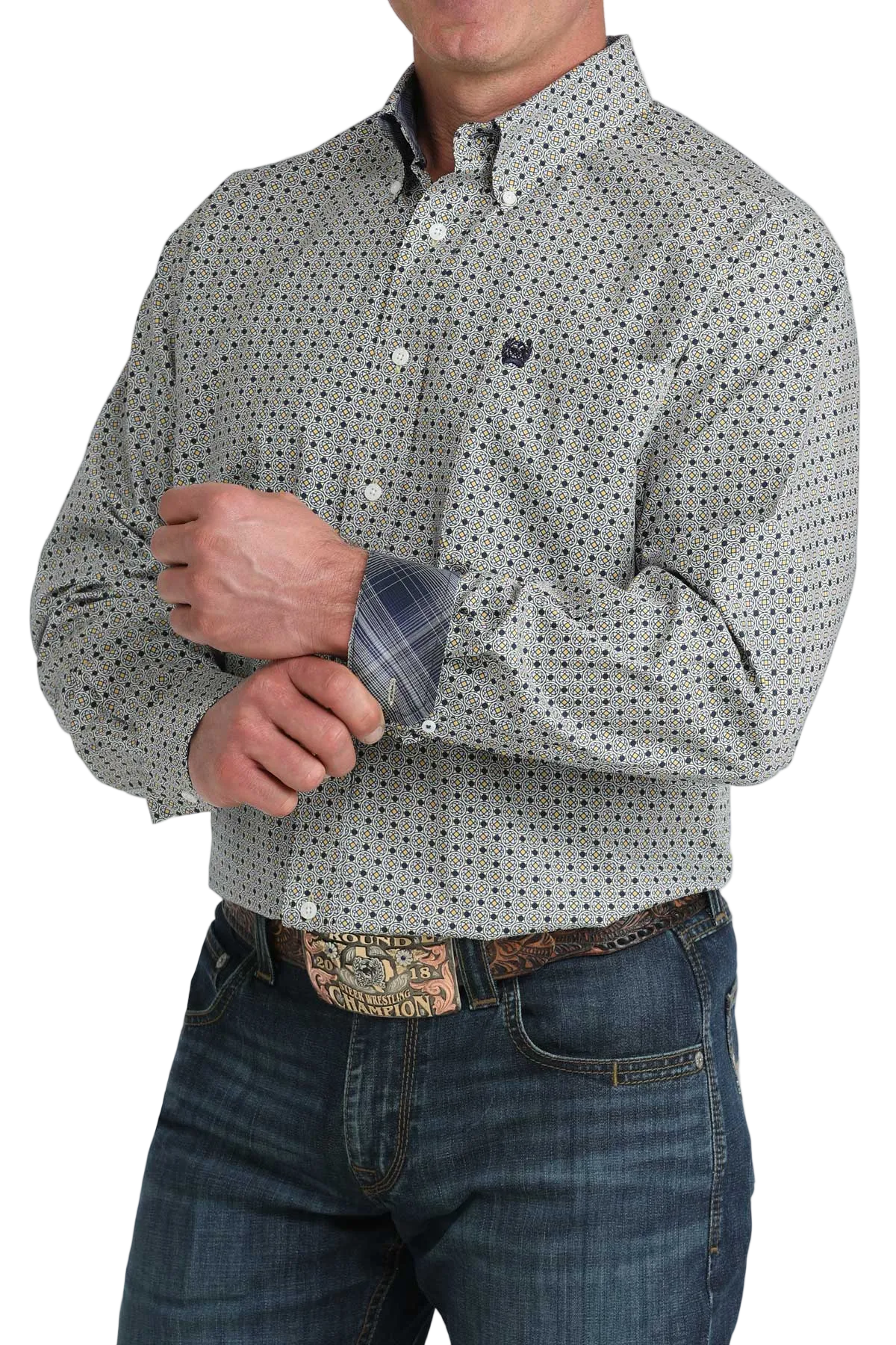 Man wearing a patterned shirt and jeans with a white background