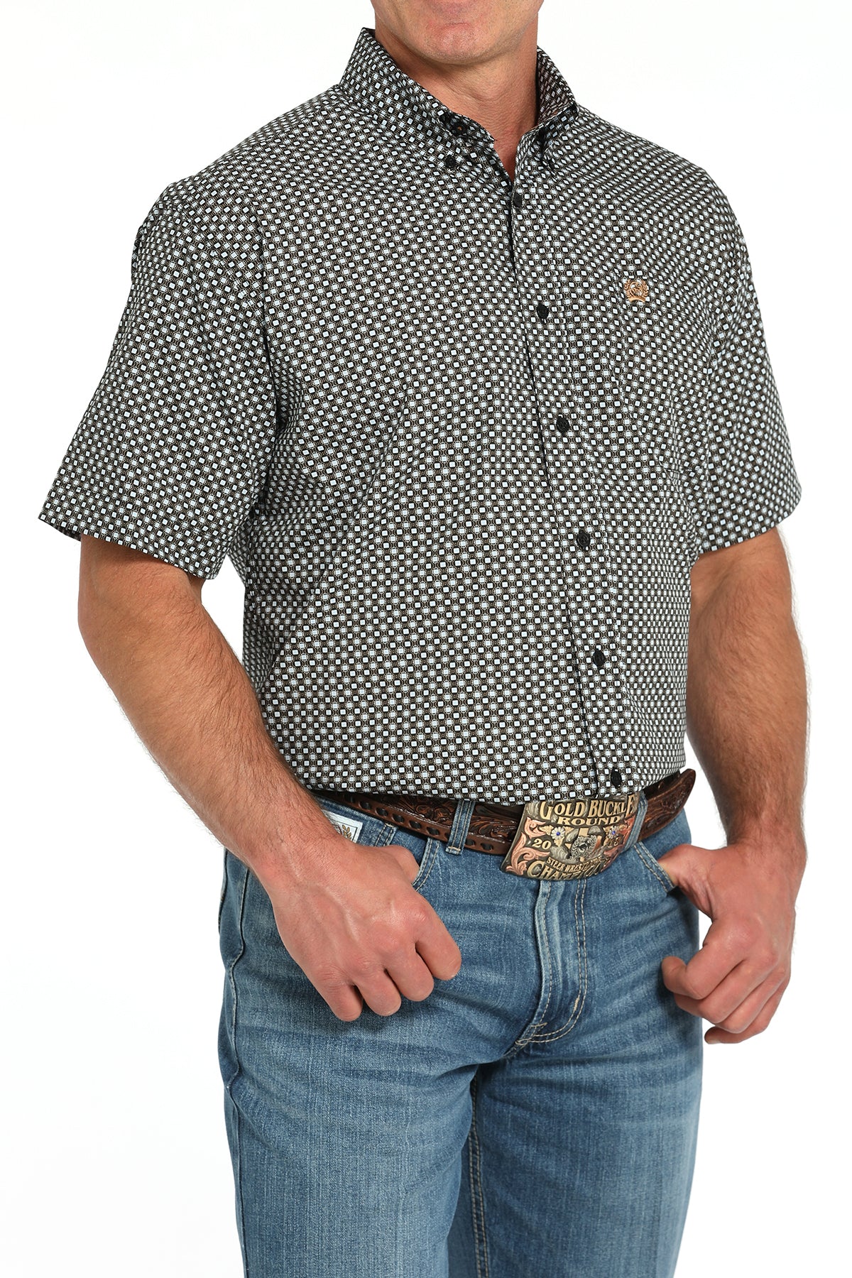 Man wearing a patterned short-sleeve shirt and jeans on a white background