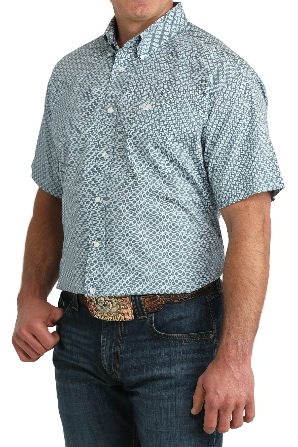 Man wearing a short-sleeve button-up shirt with a geometric pattern and jeans on a white background