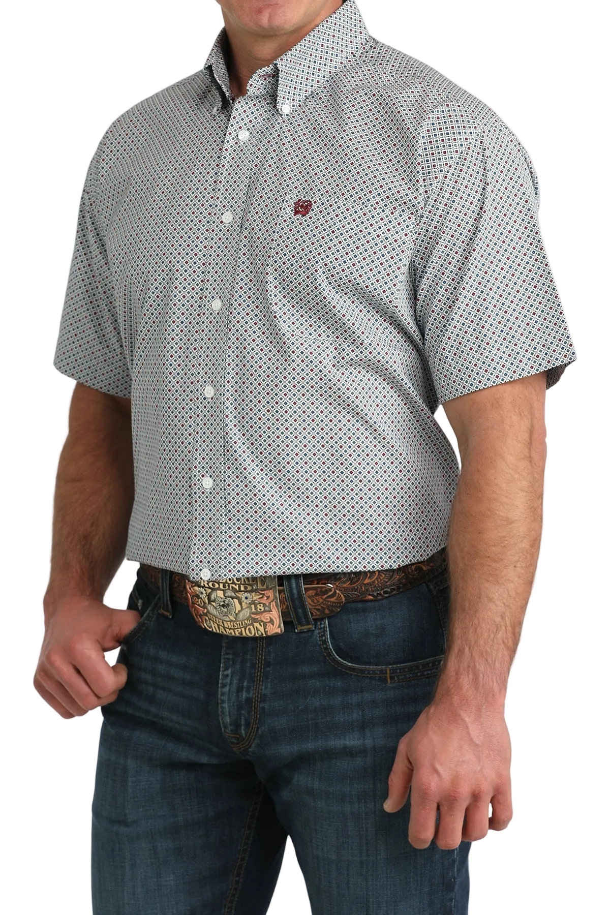 Man wearing a patterned short-sleeve shirt and jeans on a white background