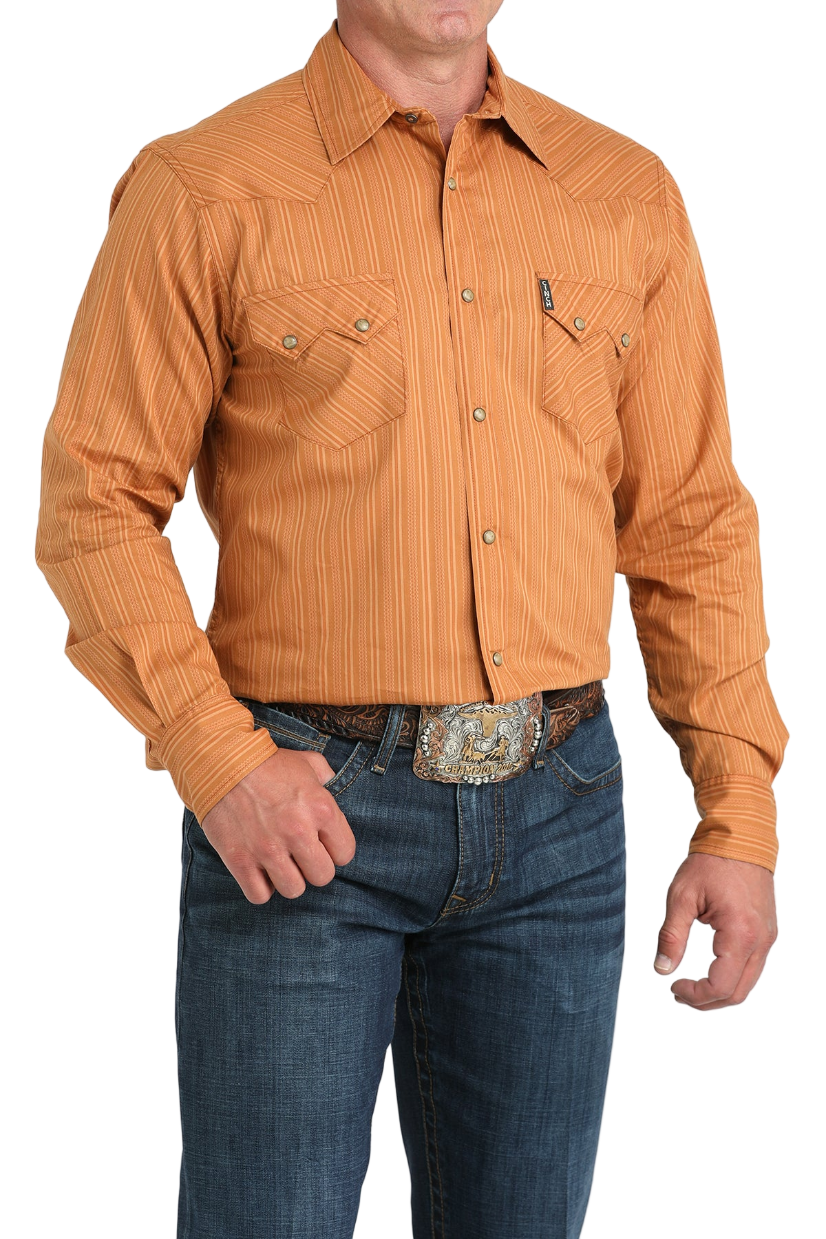 Man wearing a orange button-up shirt with blue jeans on a white background