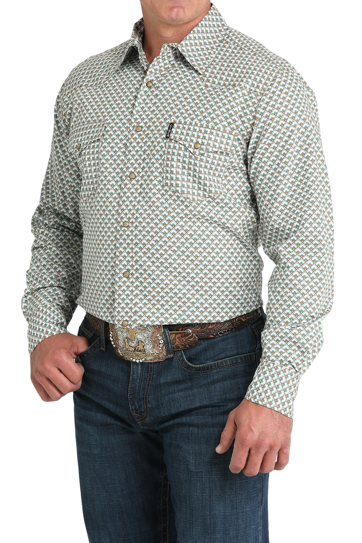 Man wearing a light gray patterned button-up shirt with blue jeans on a white background