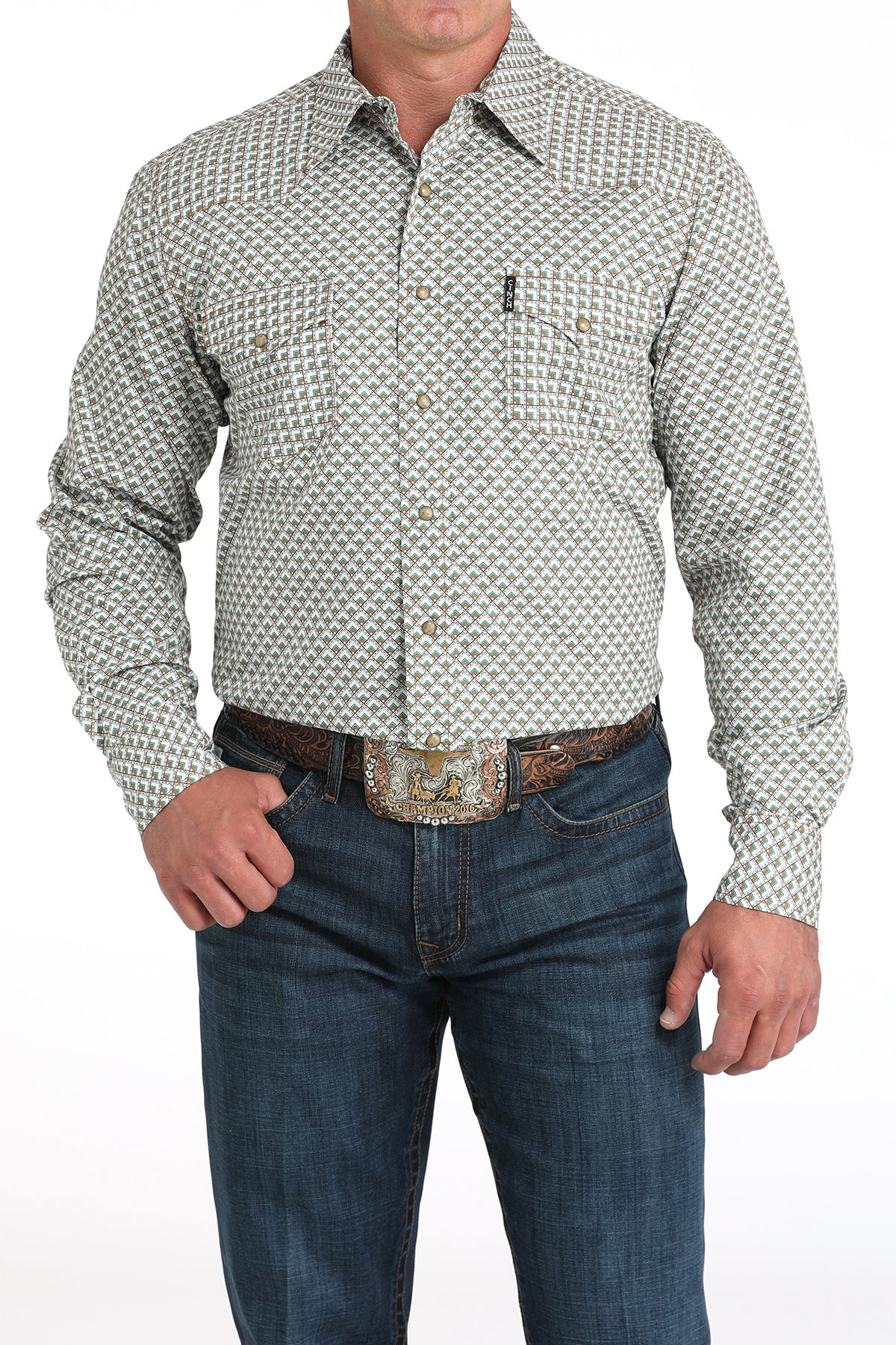 Man wearing a long sleeve button-down shirt in white, with jeans and a belt 