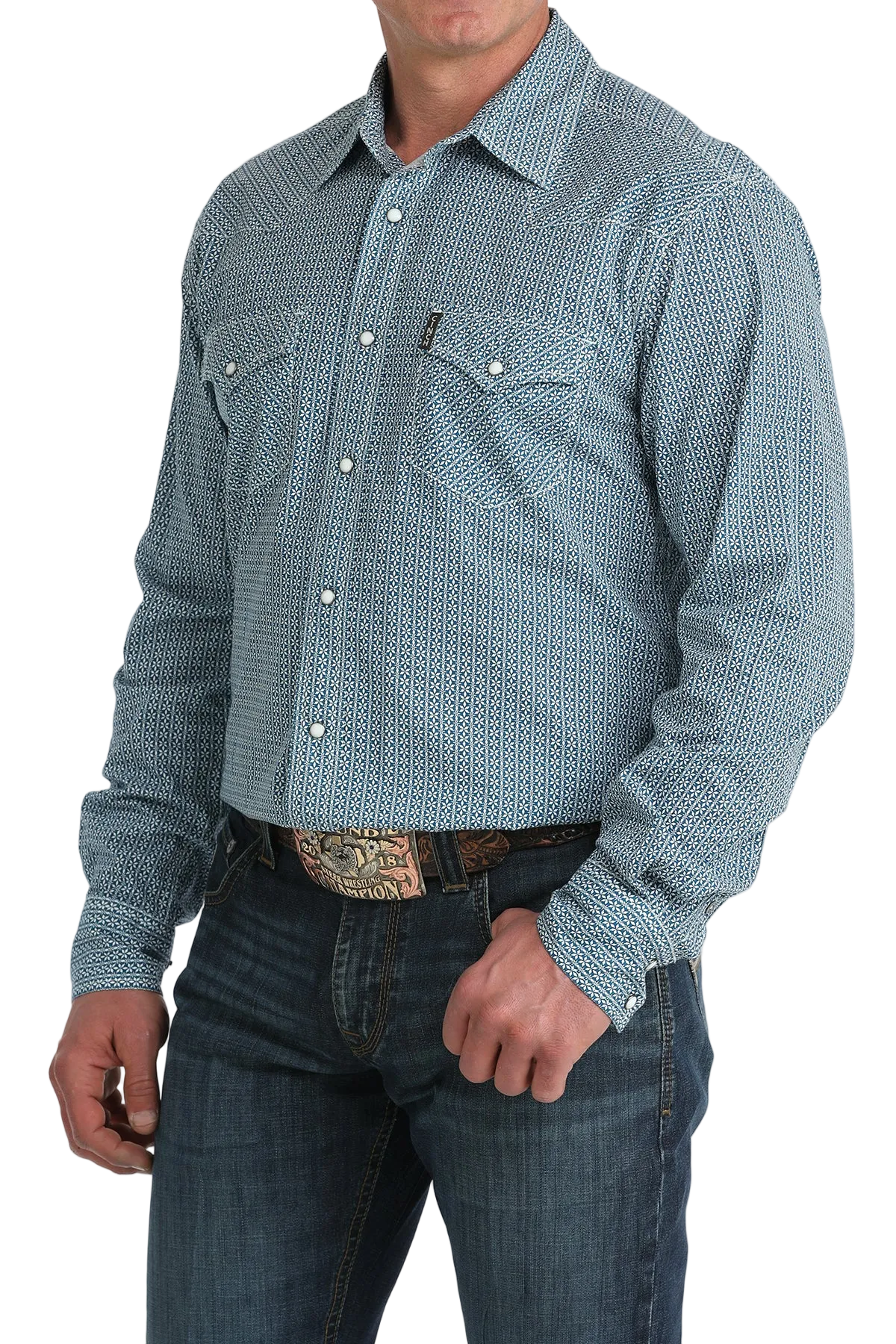 Man wearing a blue patterned long-sleeve shirt and jeans on a white background