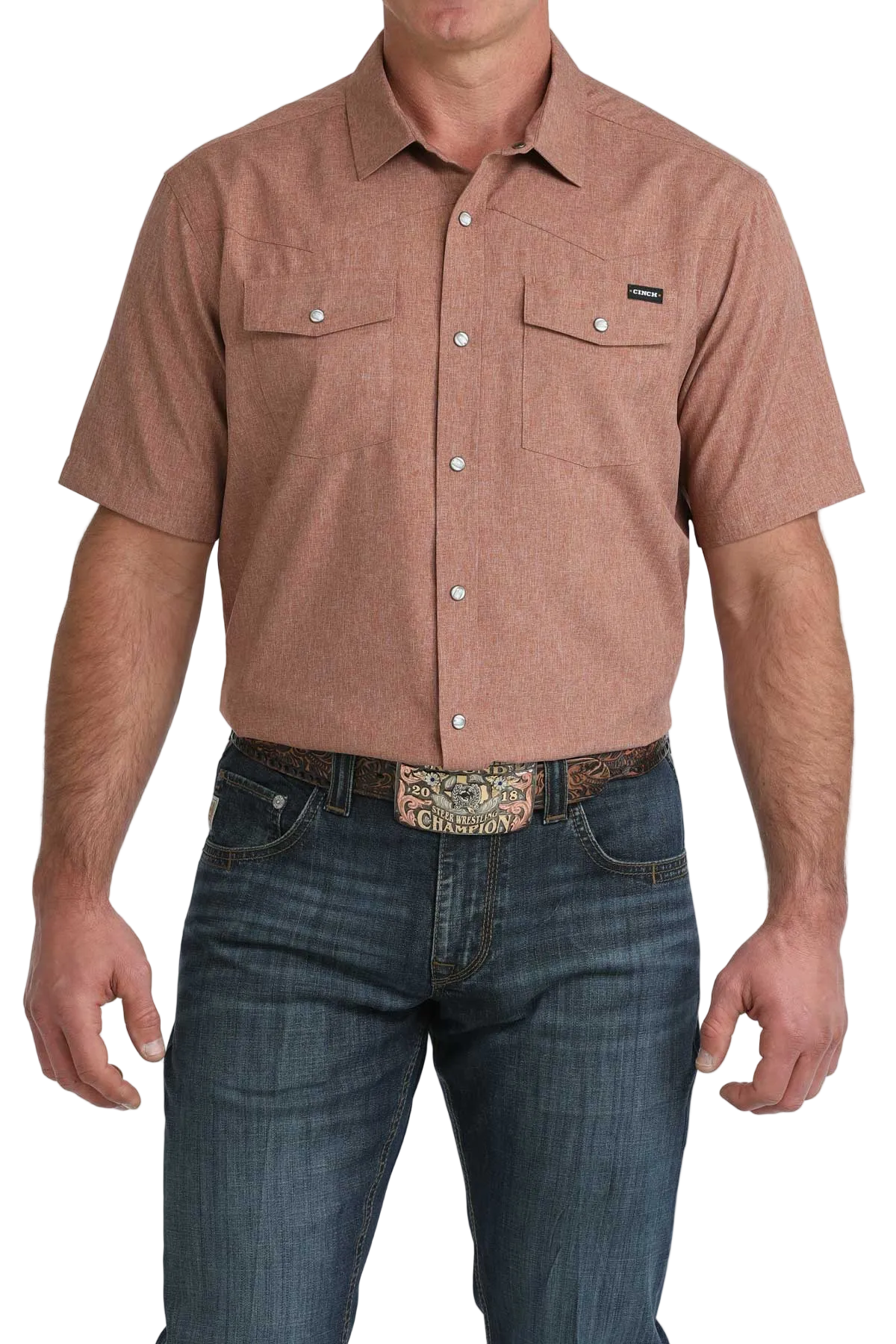 Man wearing a brown short-sleeve shirt and blue jeans on a white background