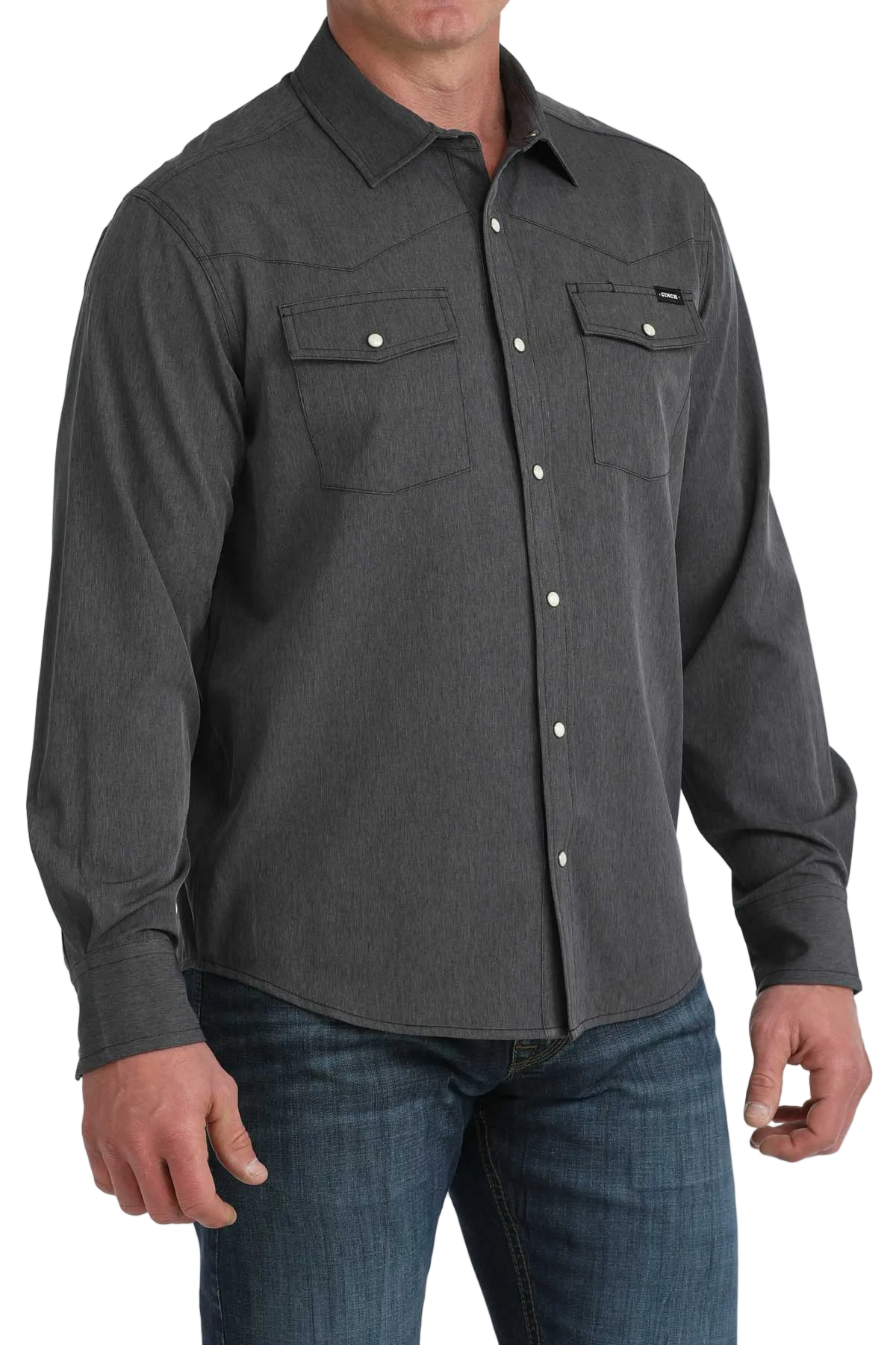 Man wearing a dark gray button-up shirt with two front pockets on a white background