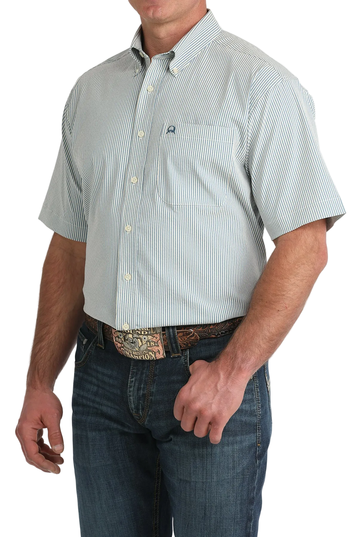 Man wearing a light blue short-sleeve button-up shirt with a pattern and dark jeans on a white background
